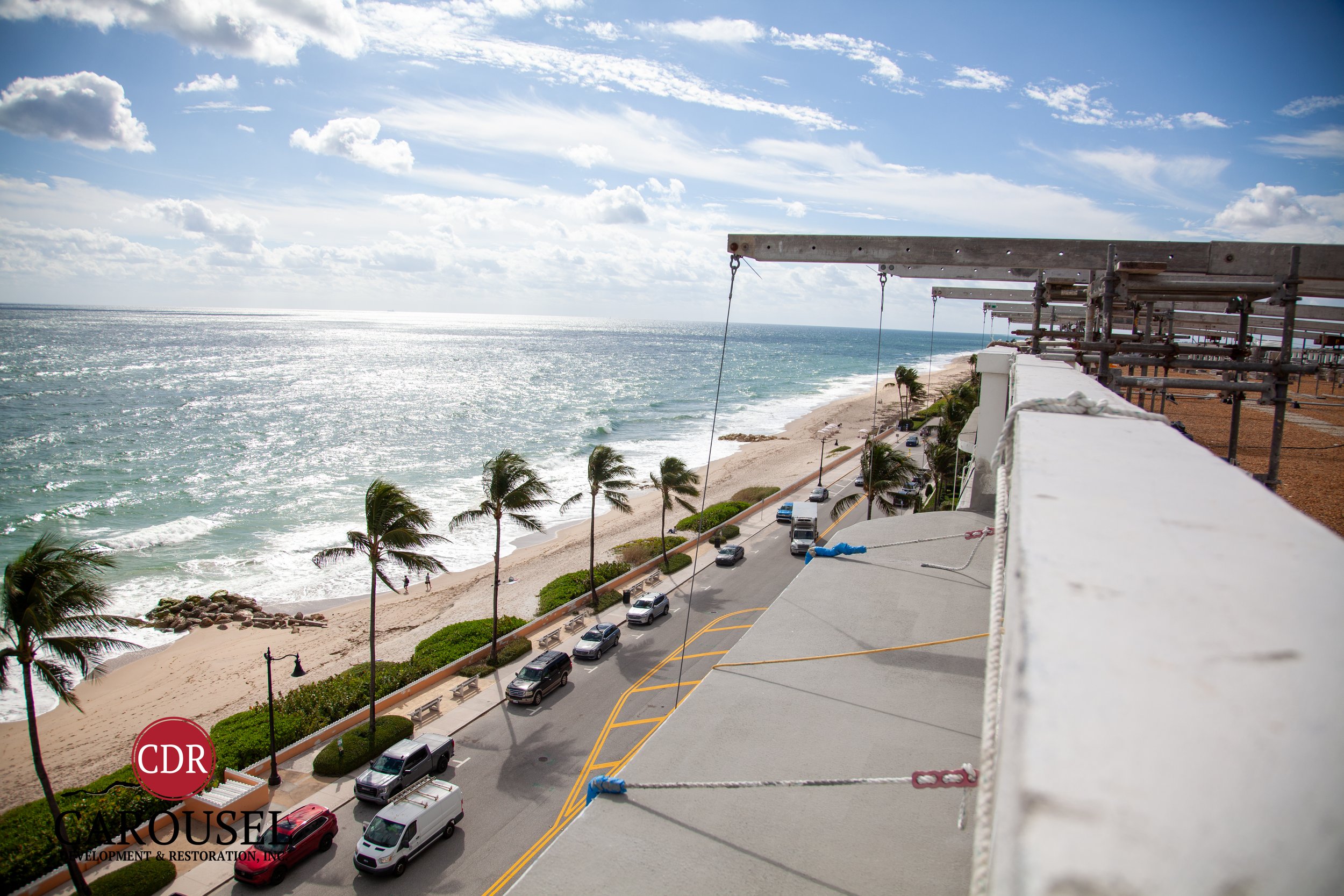 Image of beachfront building where Carousel has scaffolding to perform repairs