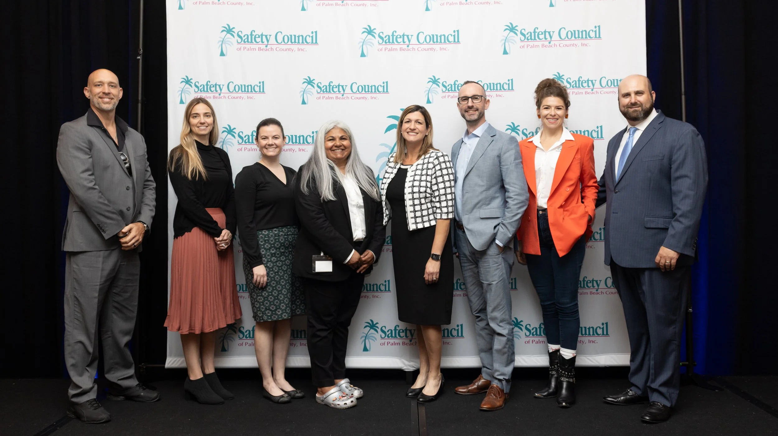 CDRI employees and others standing in front of step & repeat with Safety Council logo