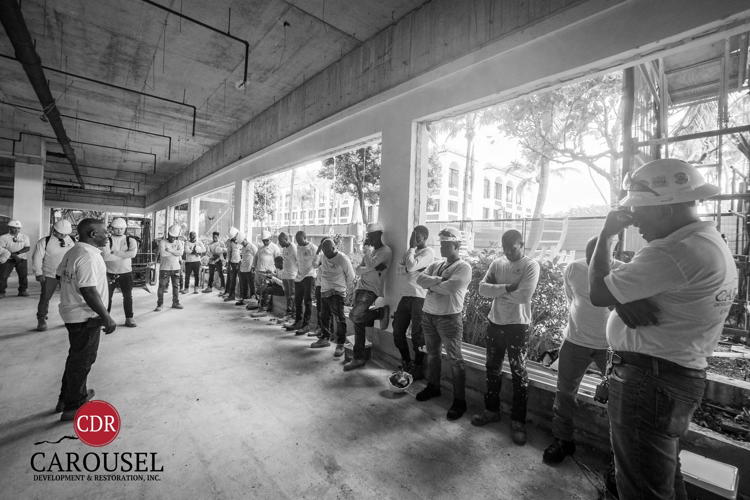 carousel employees at prayer meeting on the jobsite