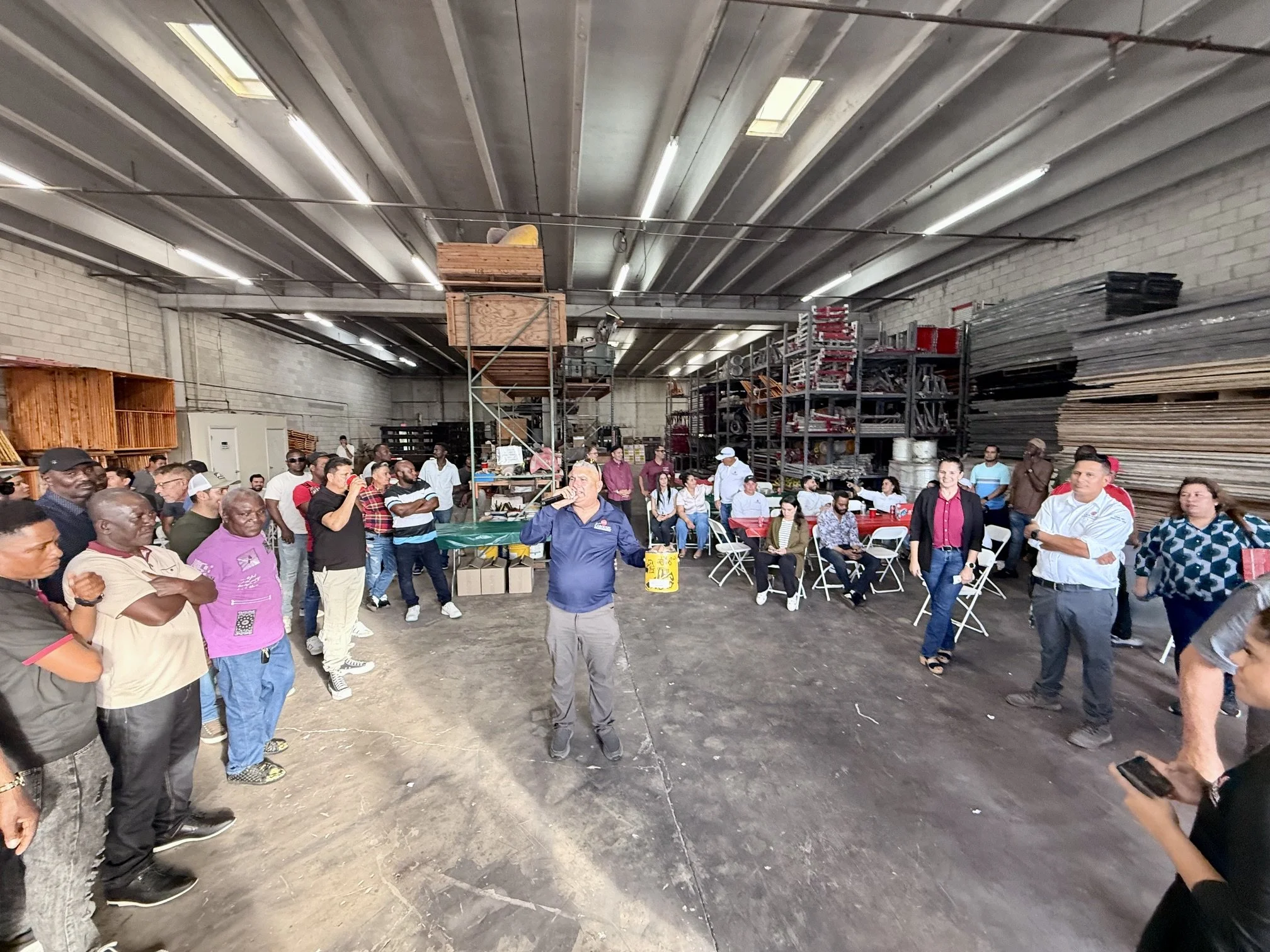 Carousel employees gather around the warehouse to celebrate success