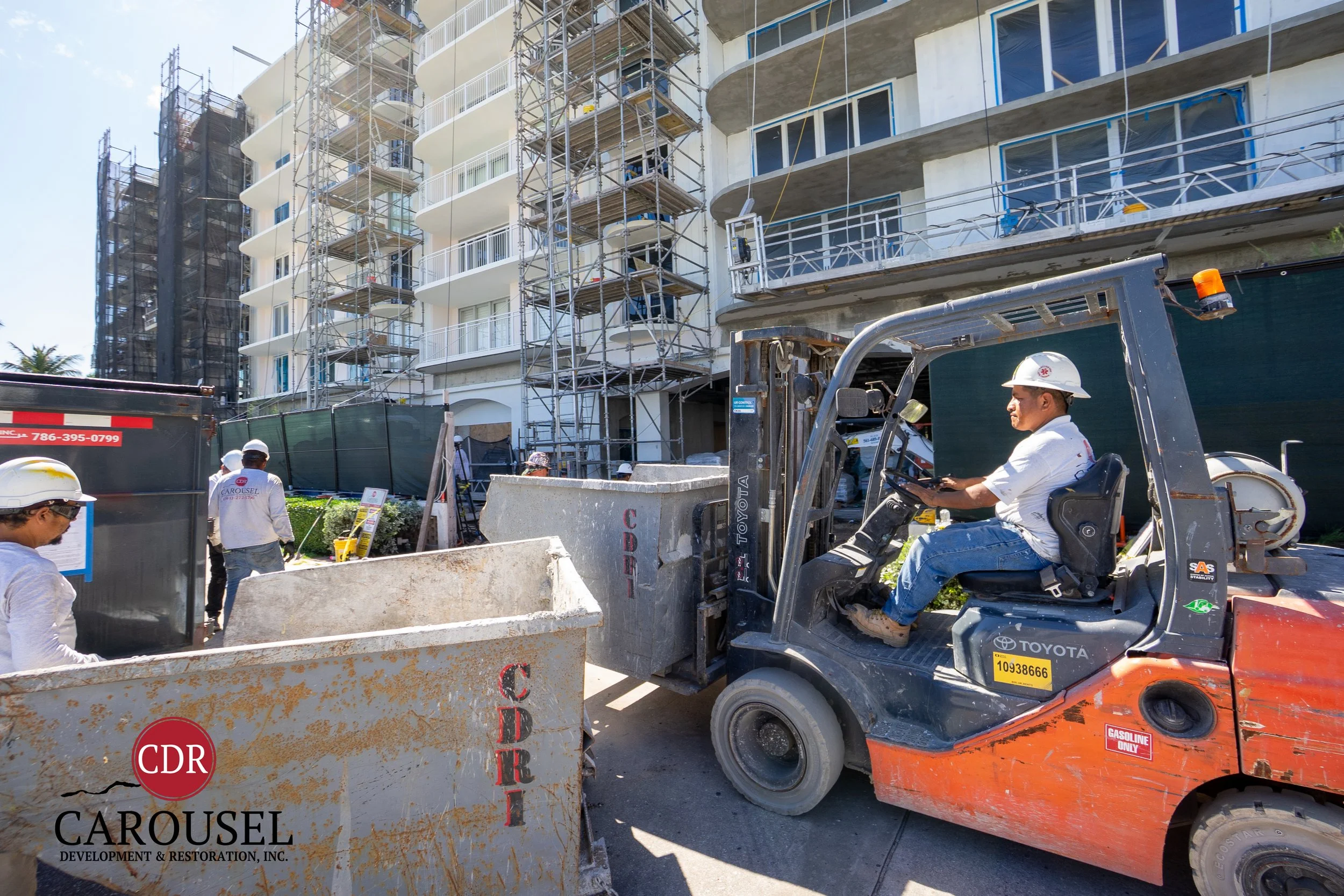 Male Carousel employee operating forklift