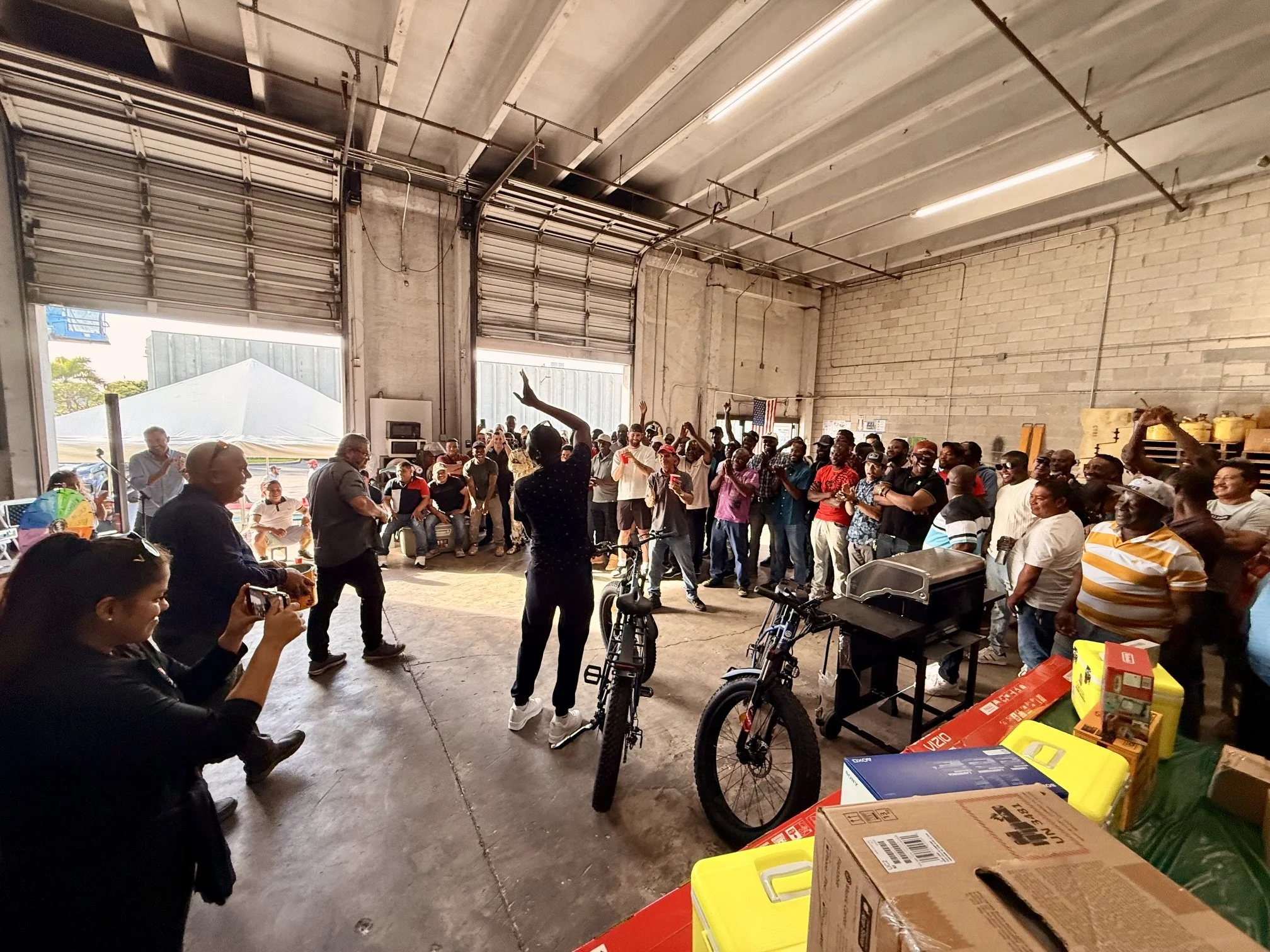 Carousel employees gather around the warehouse to celebrate success