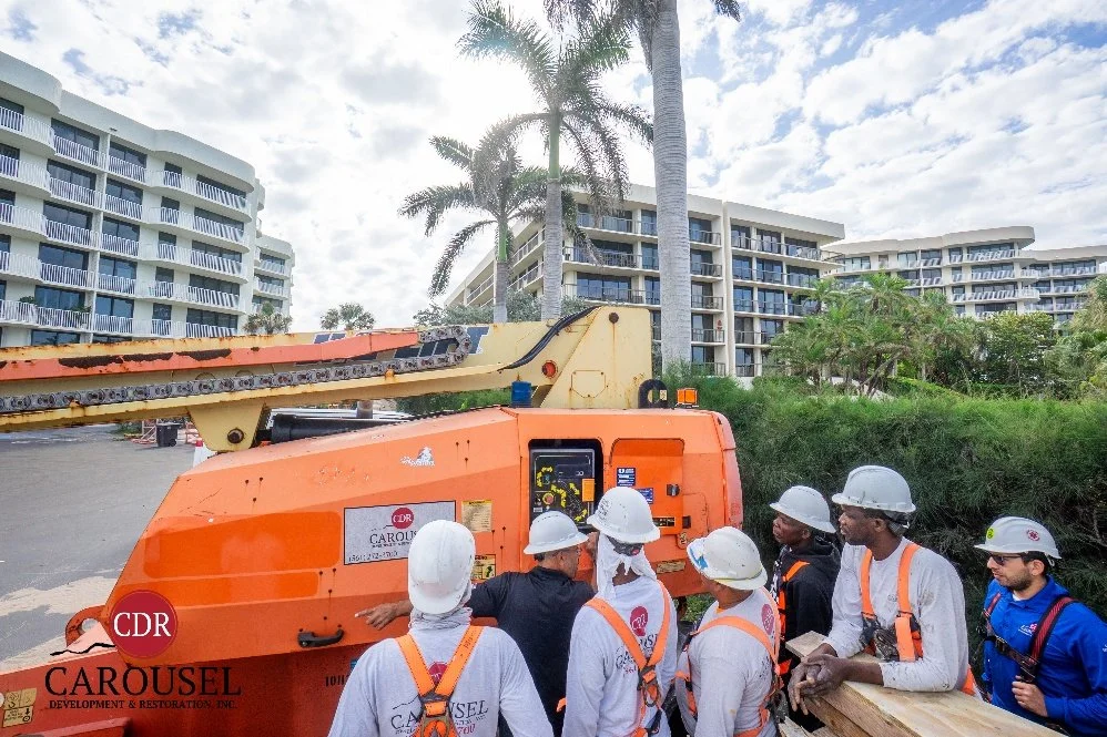 workers standing around the boom lift