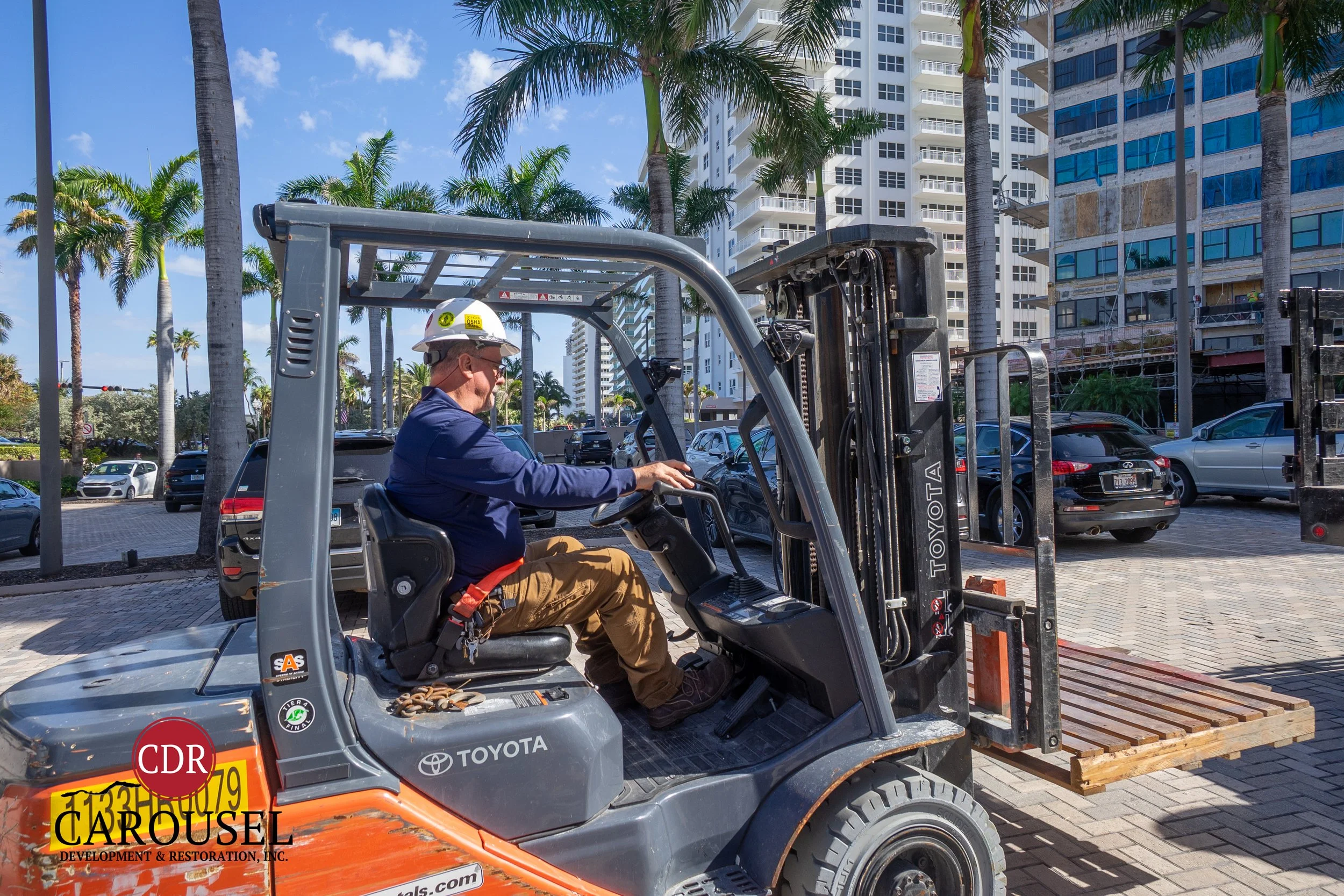 Male Carousel employee operating forklift