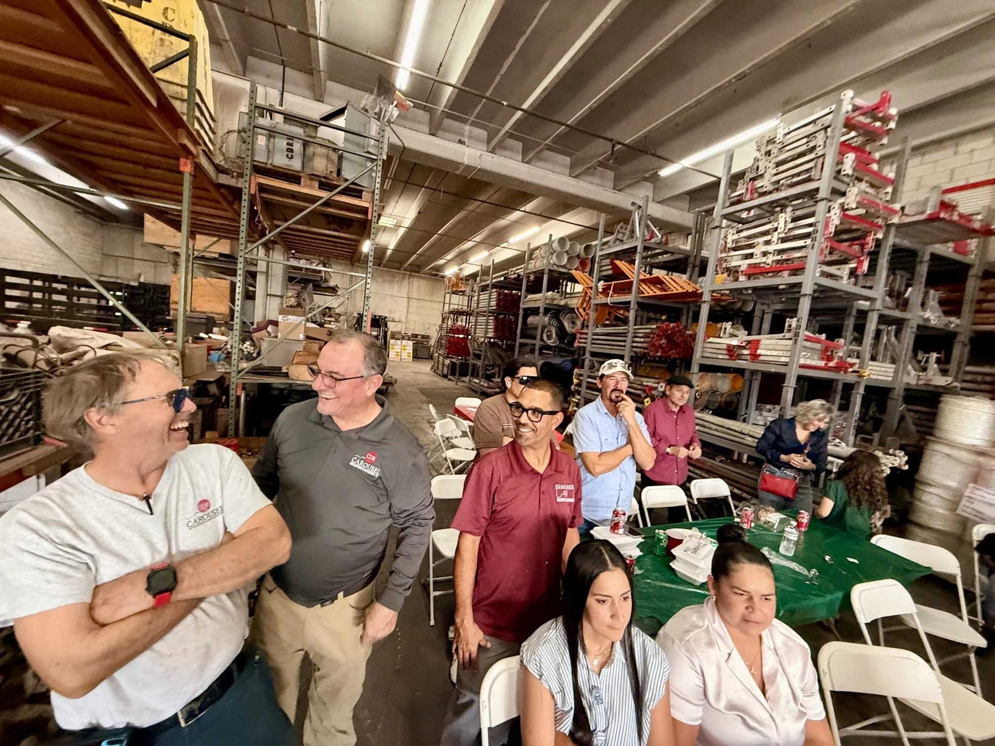 Carousel employees gather around the warehouse to celebrate success