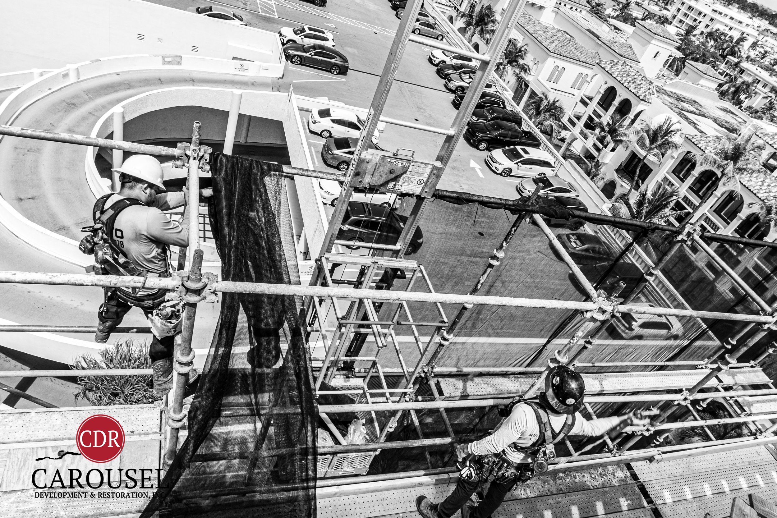 Two Carousel employees on a scaffold