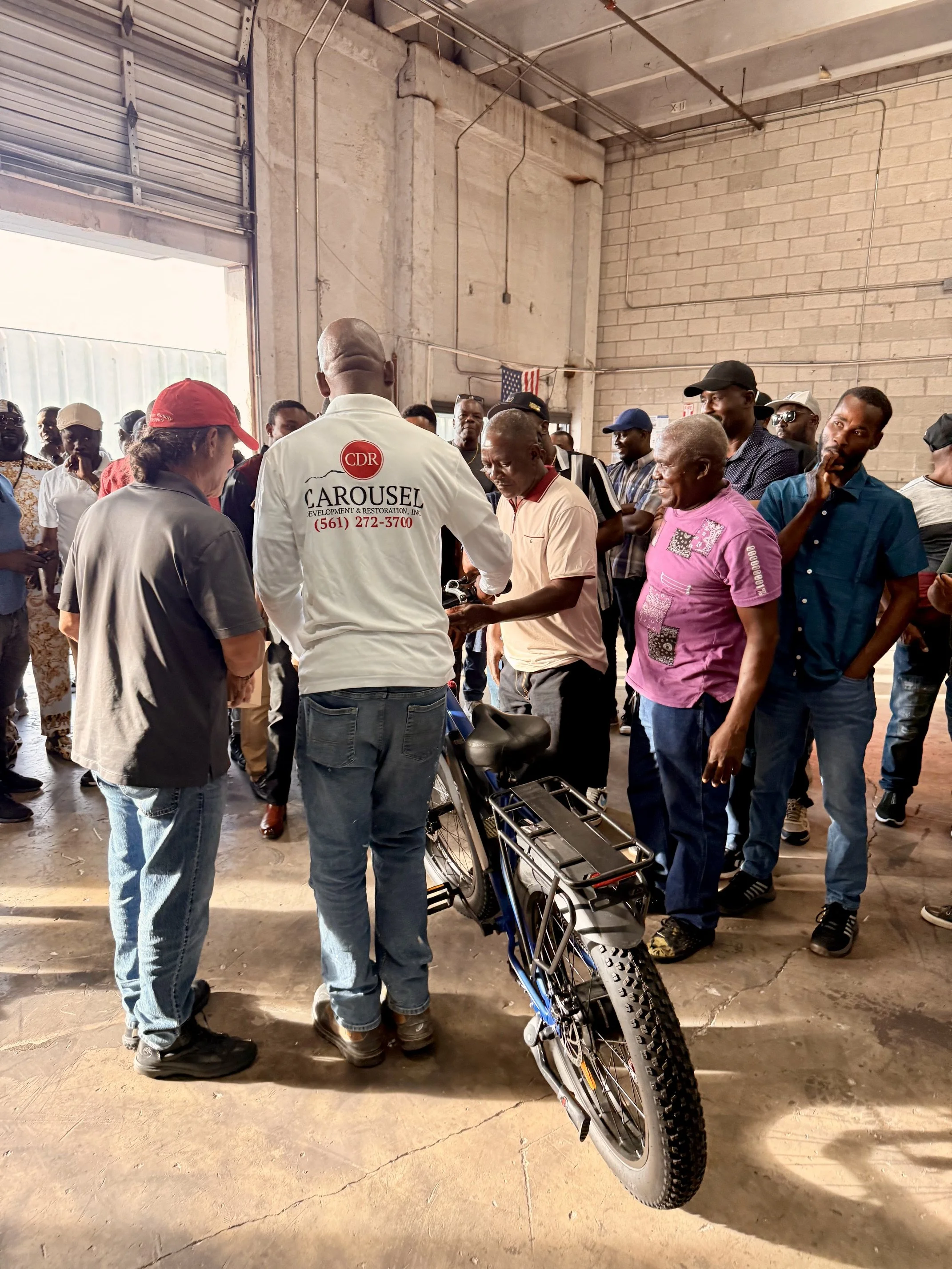 Carousel leadership gifting an e-bike to an employee