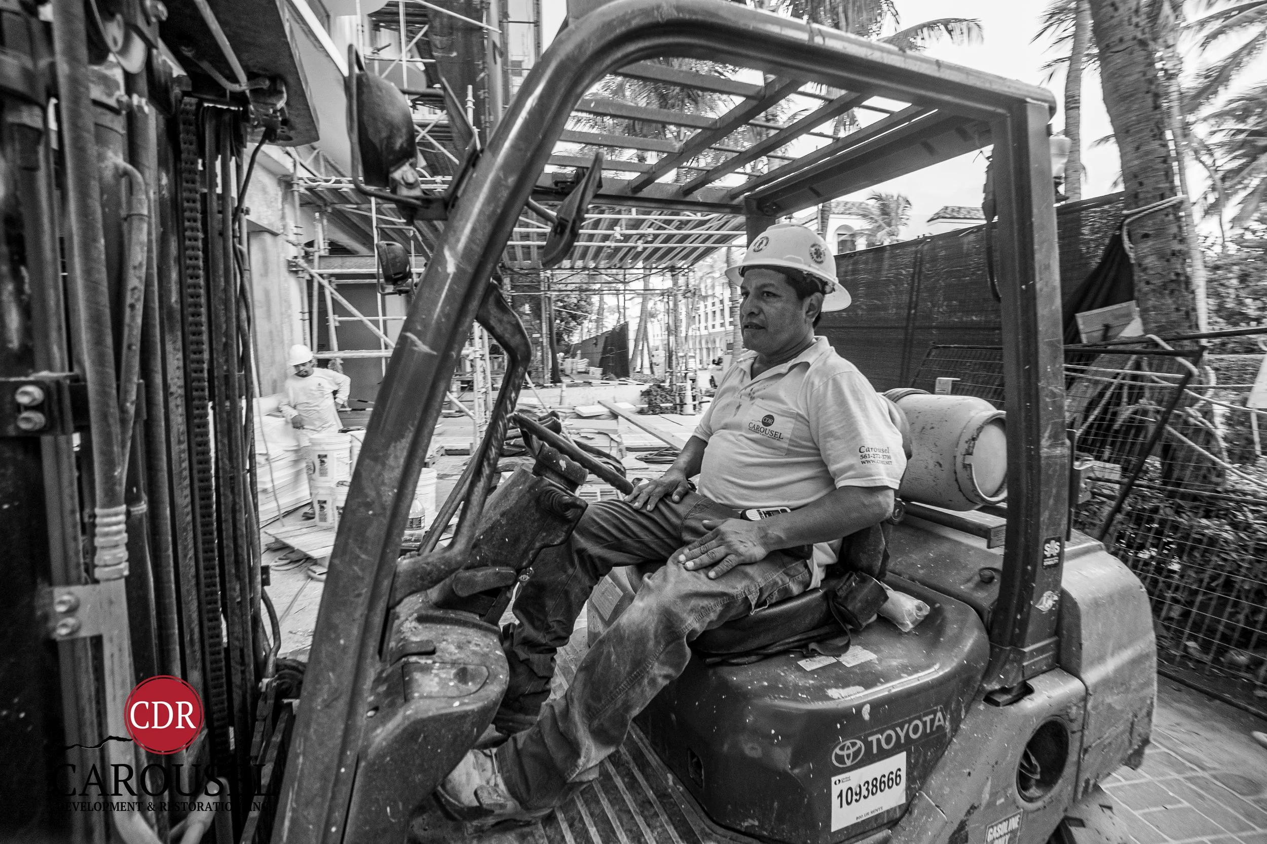 Male Carousel employee operating forklift