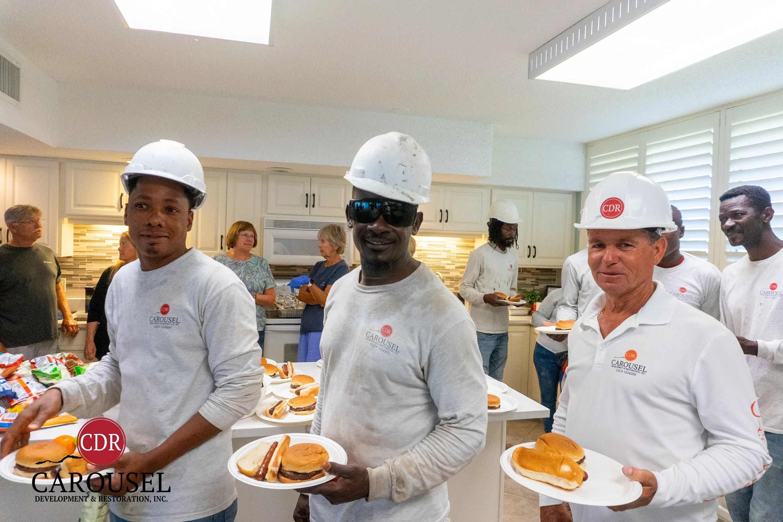 Three carousel employees with plates of food at the Starlite Condo Shows Appreciation for the Carousel Team