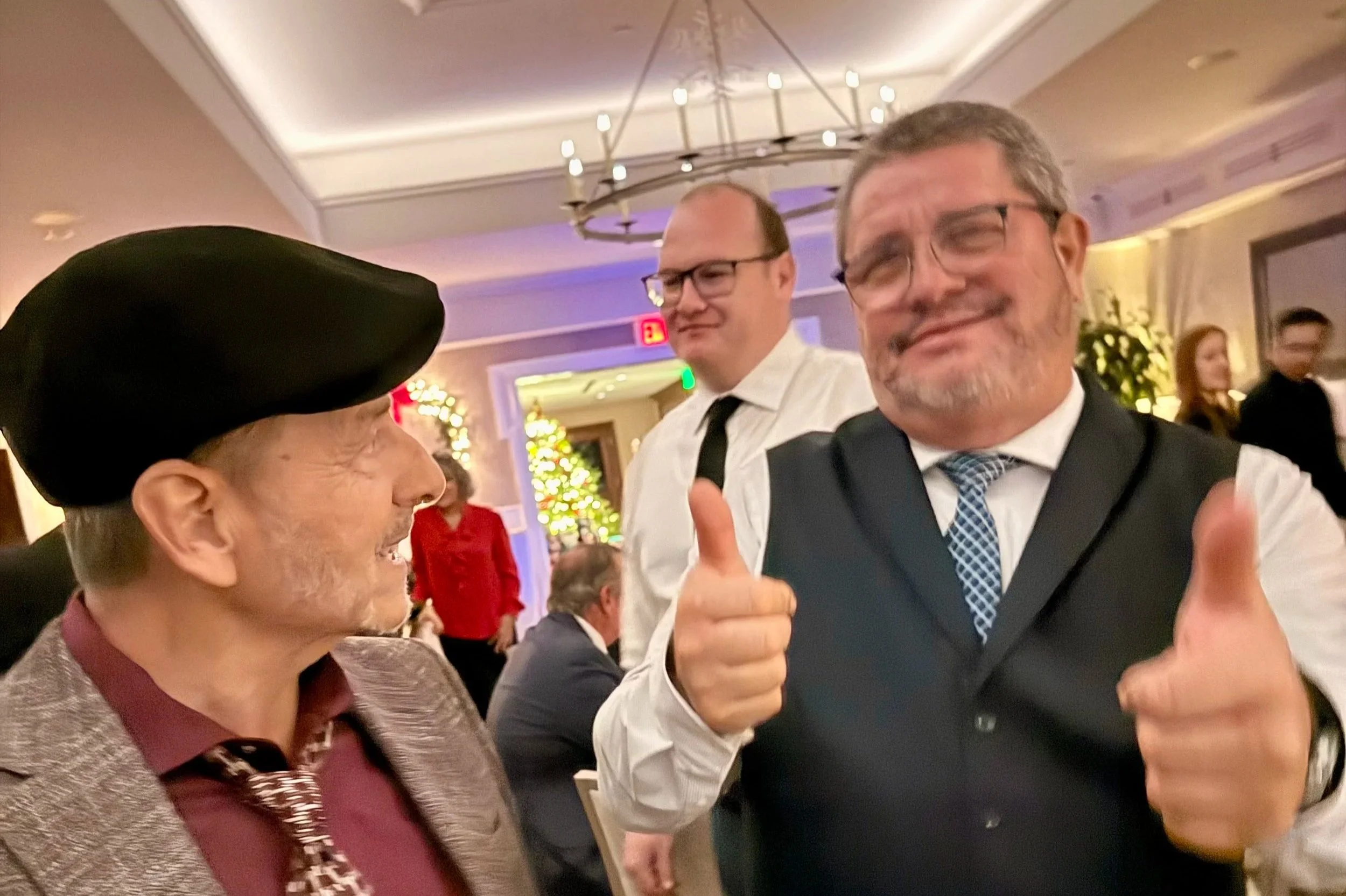 two male carousel employees celebrating at the company holiday party