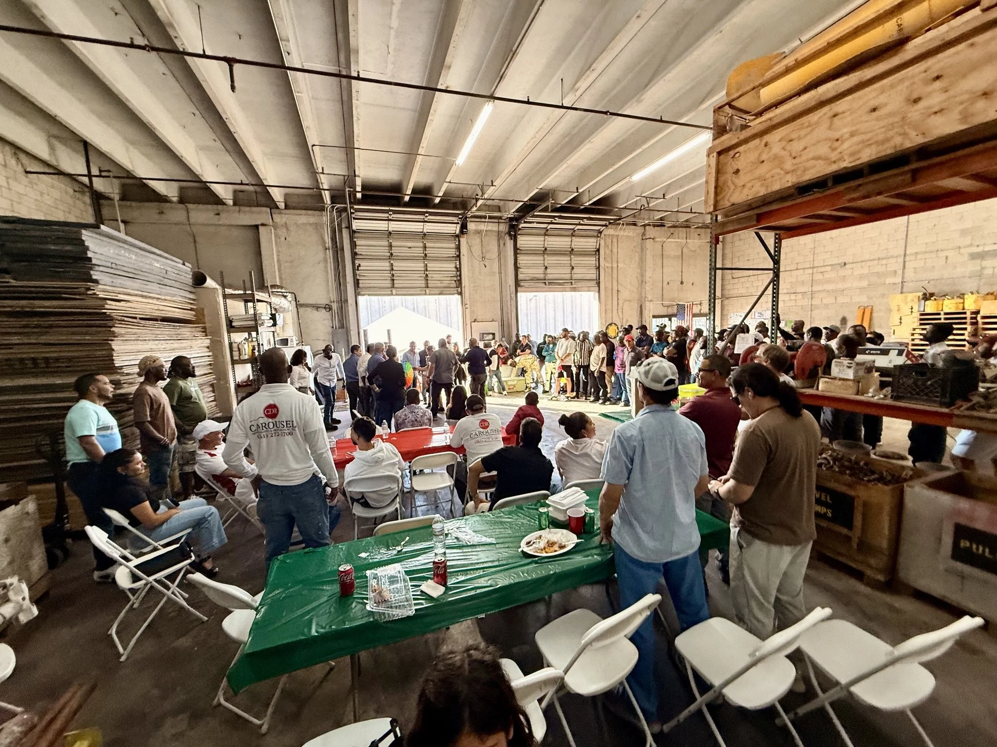 Carousel employees gather around the warehouse to celebrate success
