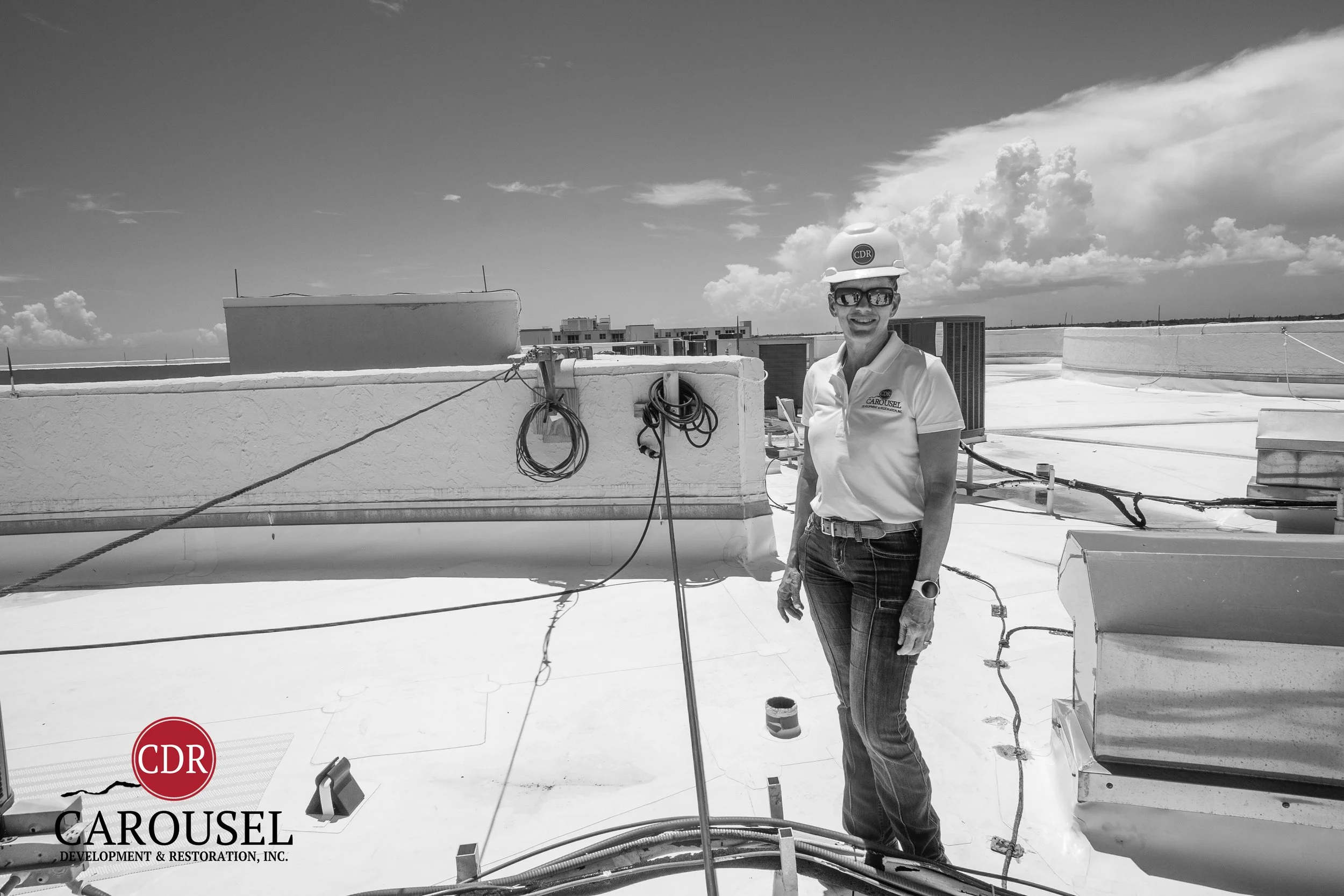 Meredith Griffin working on a jobsite roof posing for photo