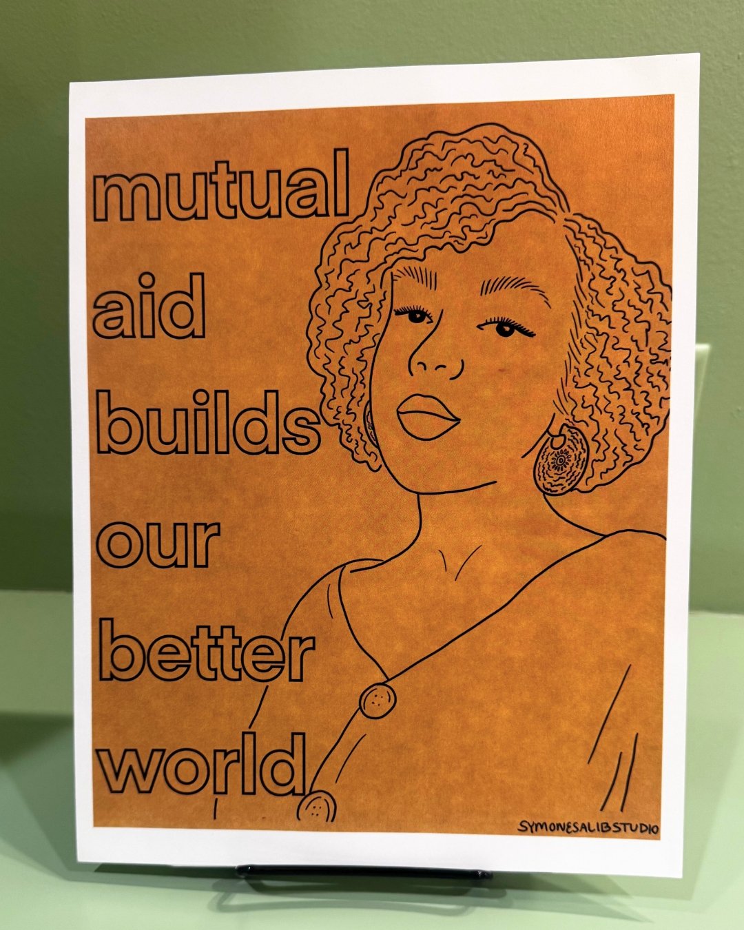 When the systems we rely on fall short, communities rise up.

&quot;Mutual Aid Builds Our Better World&quot; by Symone Salib (@symonesalibstudio), from our permanent collection, captures a powerful truth about resilience in uncertain times.

As gaps 