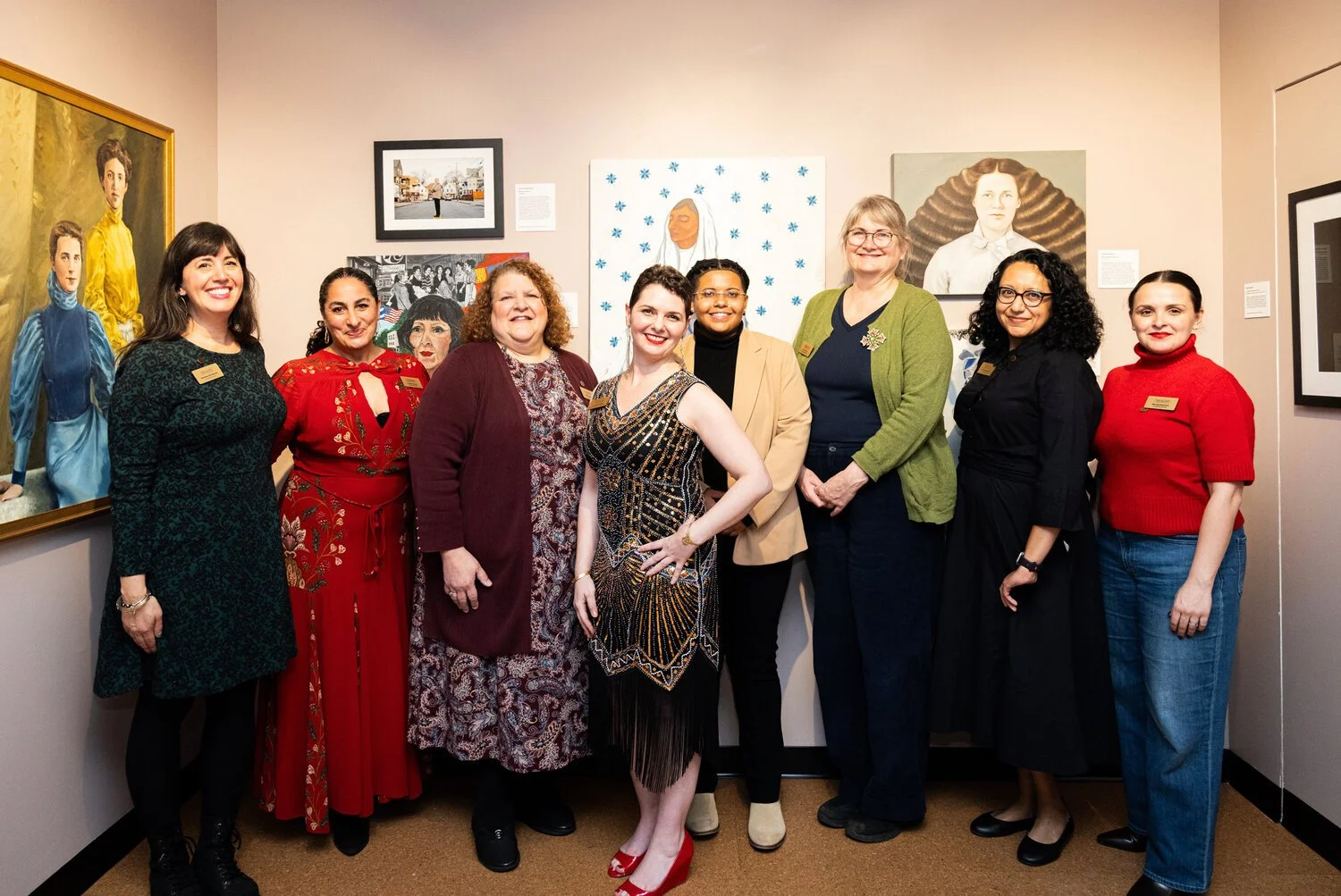 Founding board members and executive director of The Alcove pose together in the Portrait Gallery, surrounded by paintings of historic women, for the Leading Ladies feature in Hey Rhody magazine.