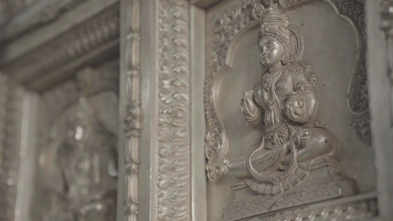 Detailed stone statue of a seated Mahavidya goddess, one of the Ten Mahavidyas, displayed in an ornate temple niche symbolizing divine feminine power.