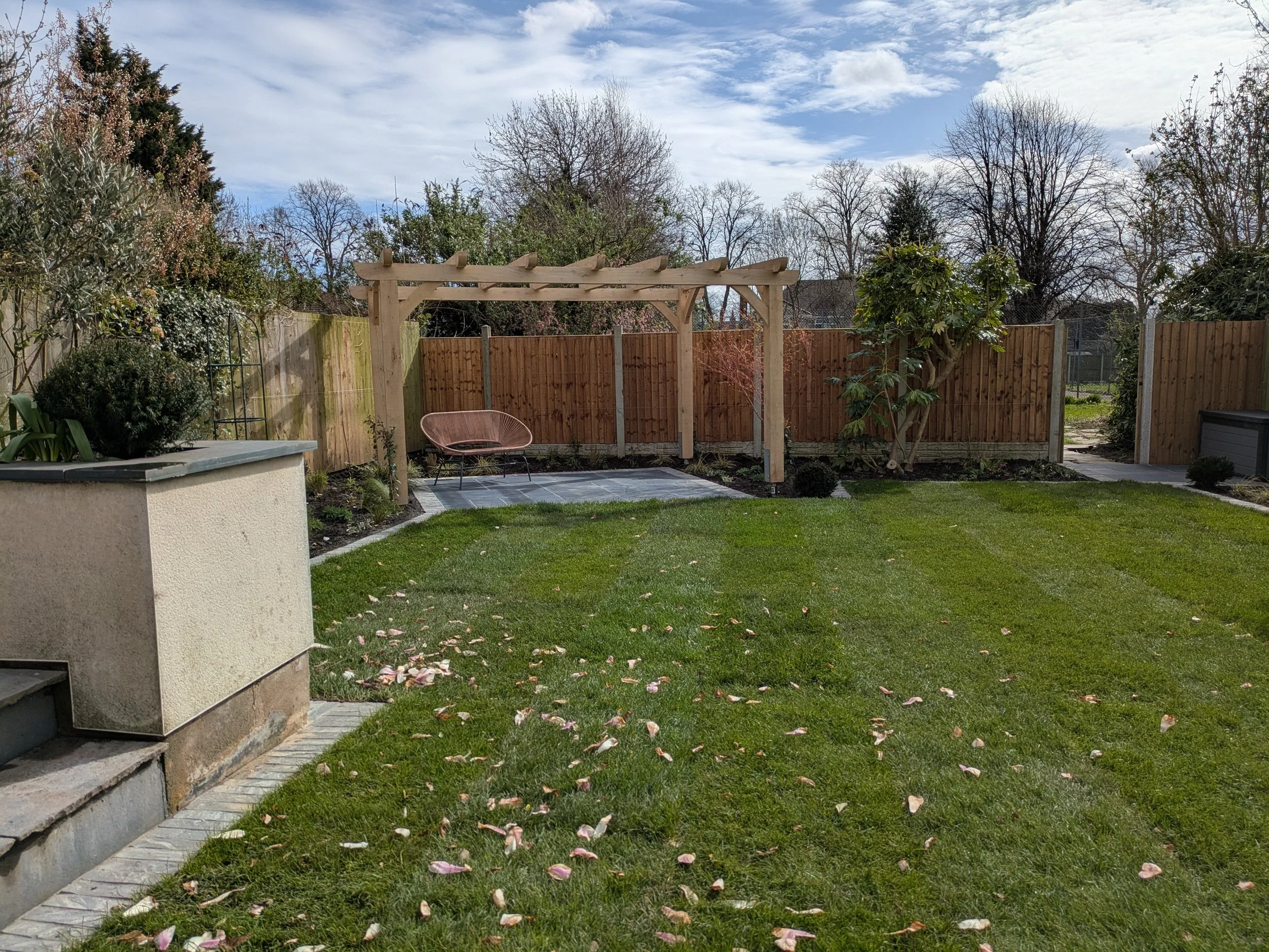 Pergola with new paving and existing raised beds