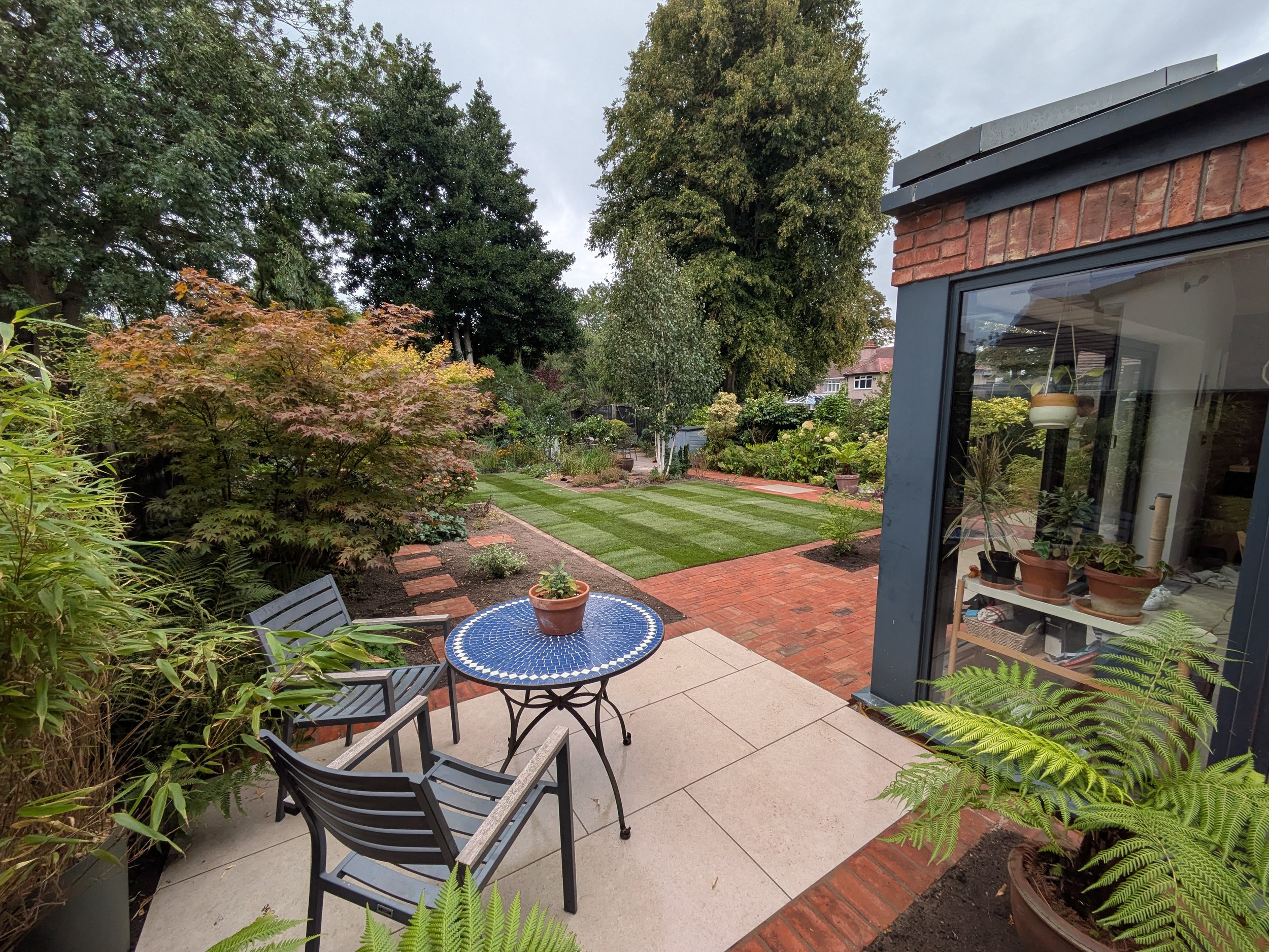 Patio for morning coffee and pastries. Porcelain and clay brick detail, supplied by London Stone