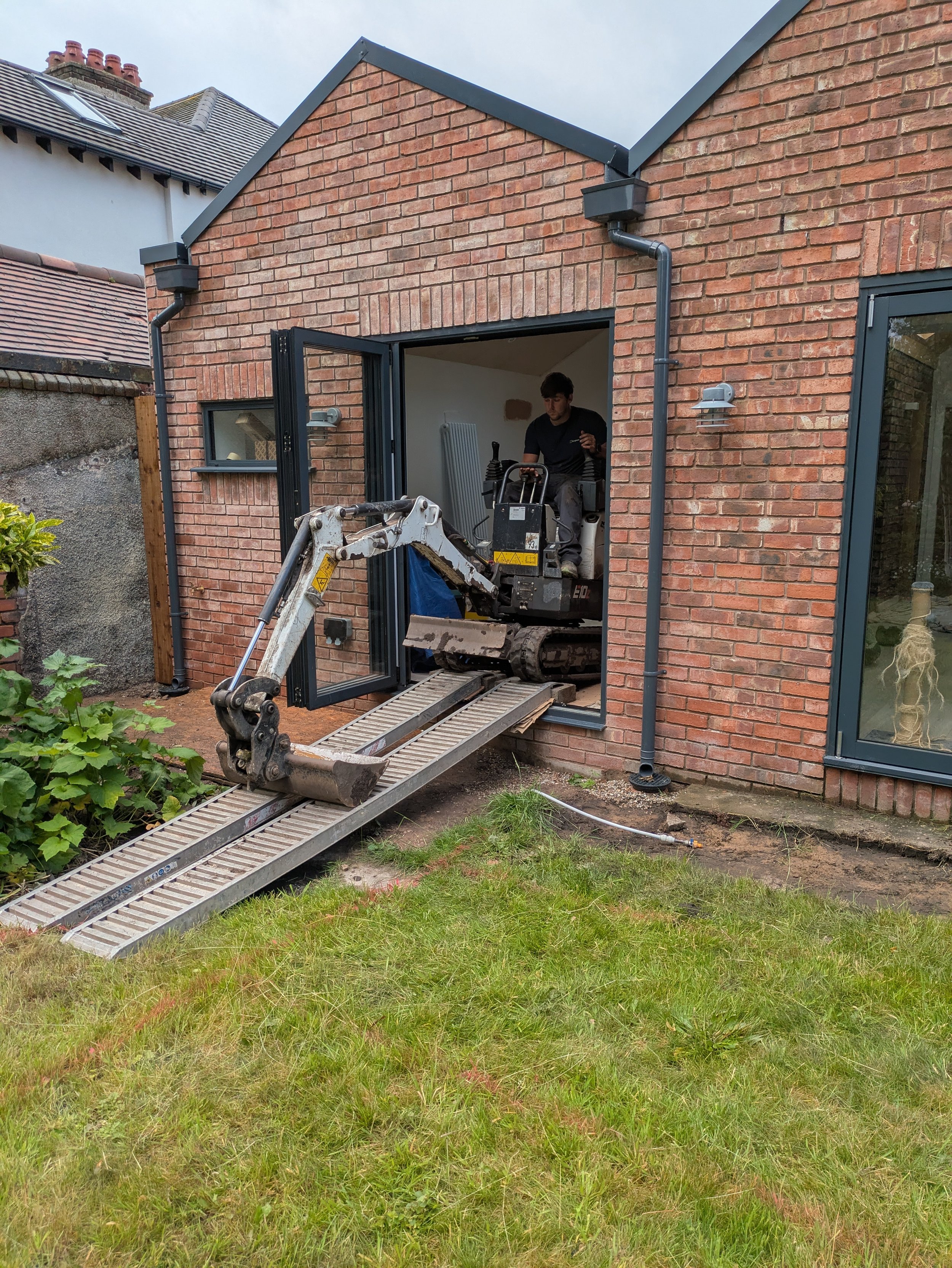 Mini digger through house.