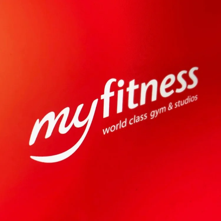 Red background with white text that reads "myfitness" and "world class gym & studios."