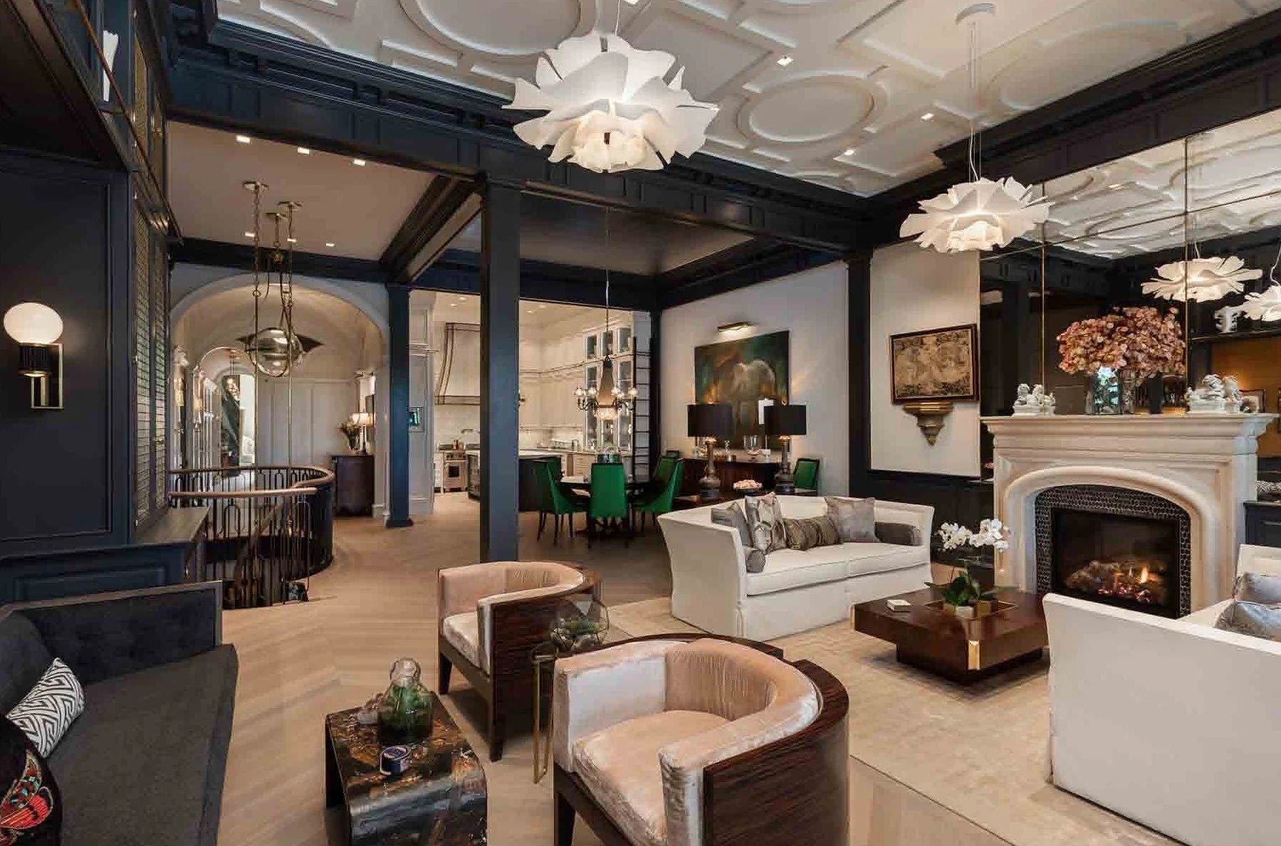 Luxury living room with various seating options, a fireplace, and elegant decor.