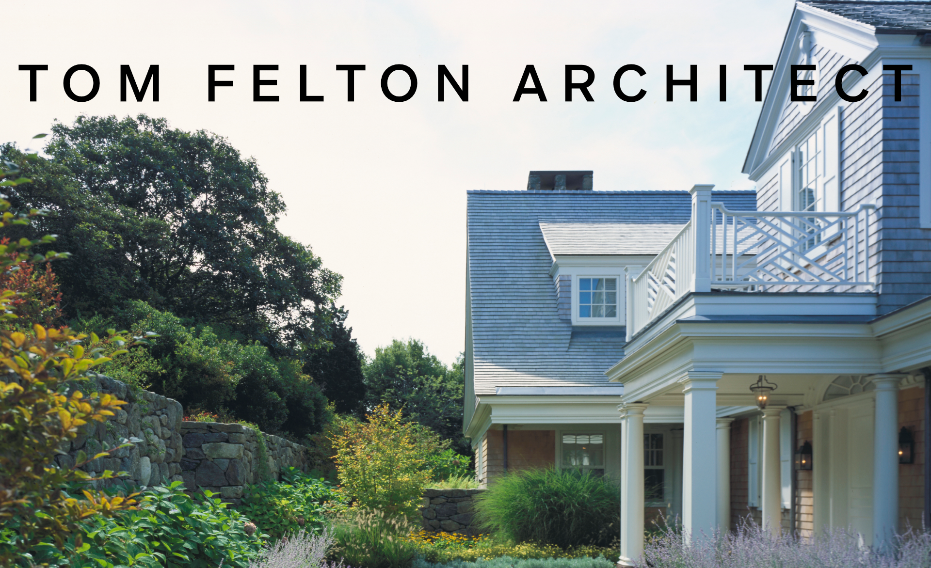 Exterior view of a large house with a porch and balcony, surrounded by lush garden and trees, with the text 'Tom Felton Architect' overlaid.