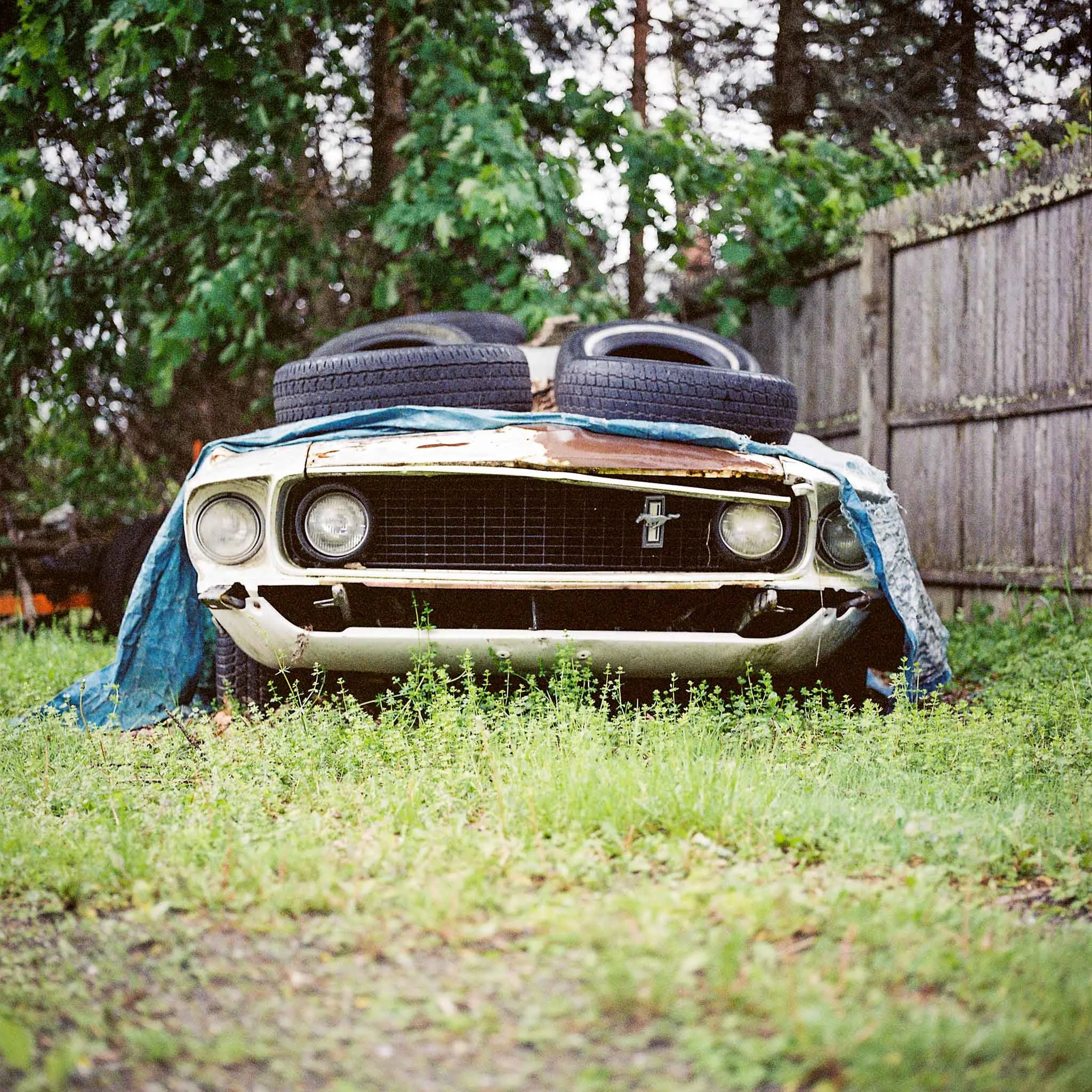 FILM_PHOTOGRAPHY_VINTAGE_CAR_TIRE_AND_CLOTH_ON_HOOD.jpg