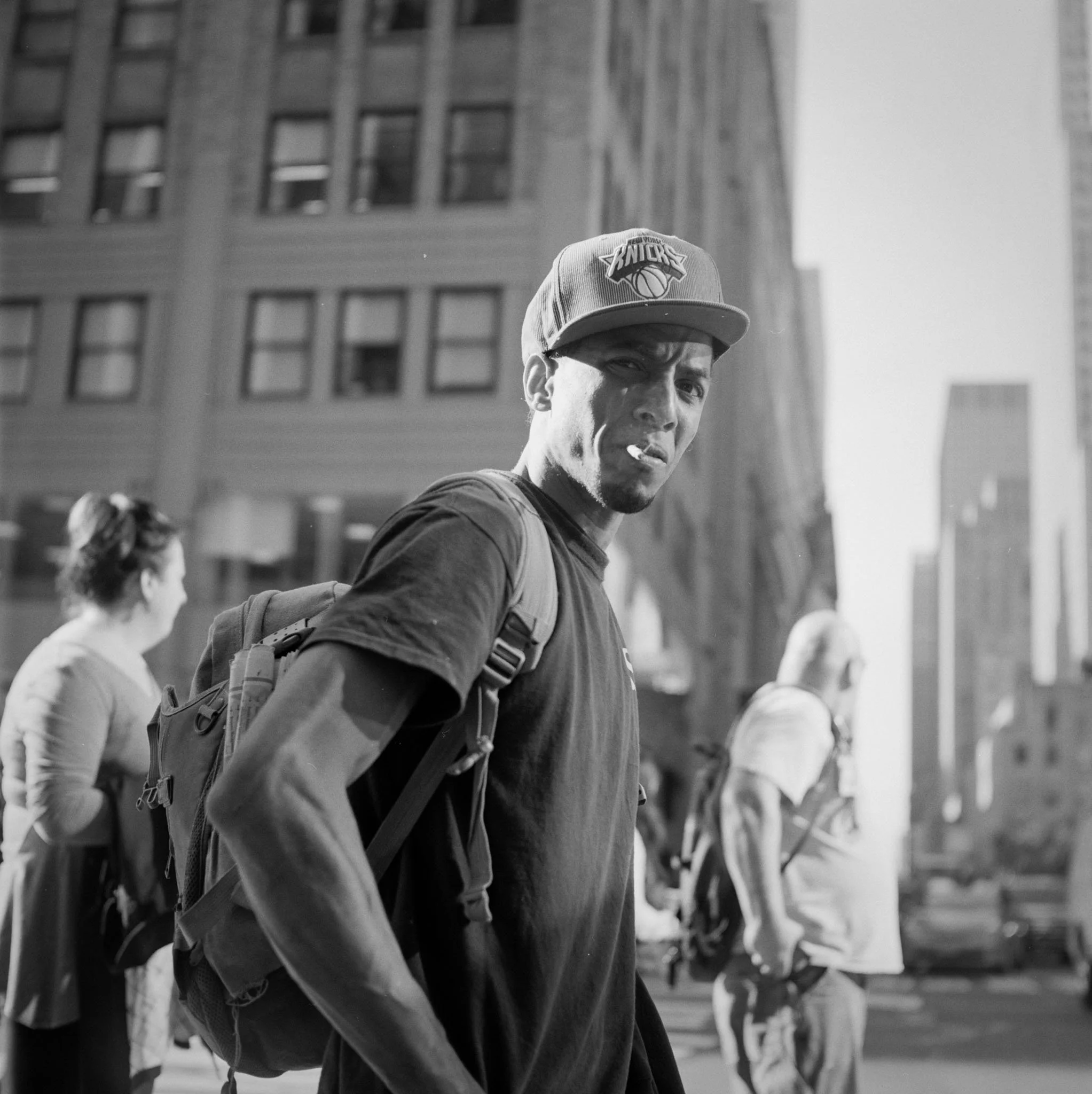 FILM_PHOTOGRAPHY_STREET_NYC_PORTRAIT_KNICKS_HAT_CIGARETTE.jpg