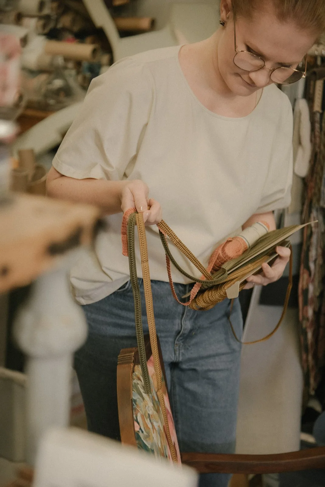 Naisyrittäjällä nauhamalleja käsissään. Kuvannut brändikuvaaja Heidi Väisänen.