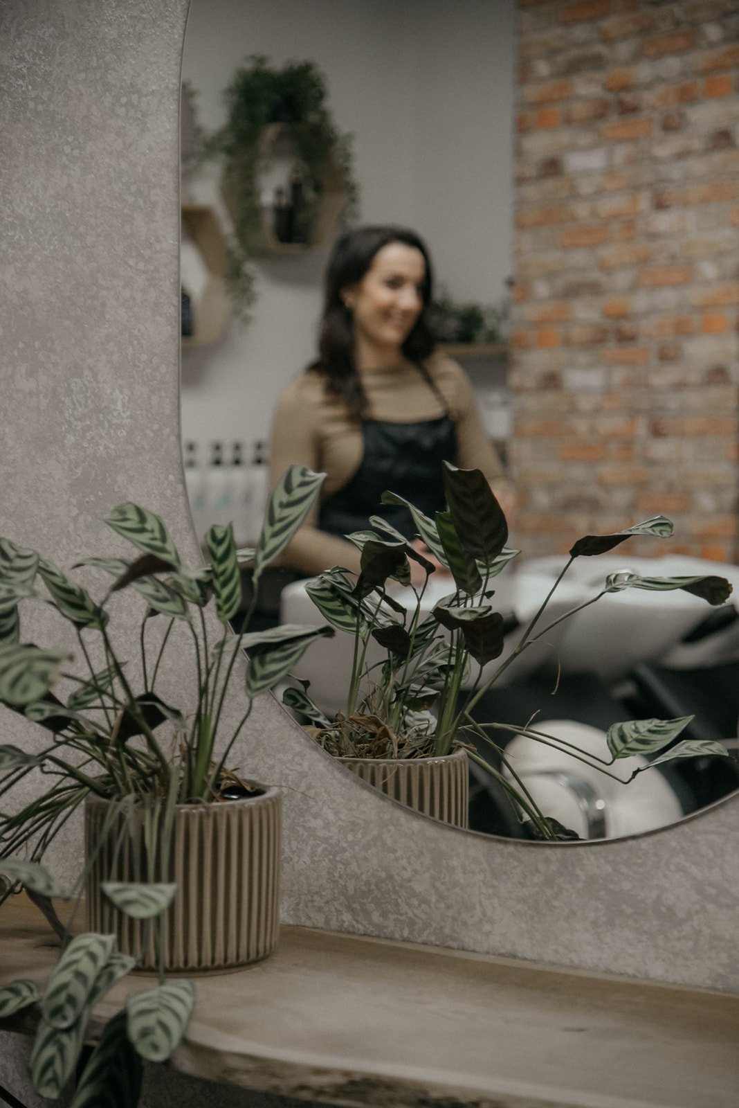 Hykken yrityskuvaus, kampaamon työntekijä näkyy peilin kautta. Kuvannut brändikuvaaja Heidi Väisänen.