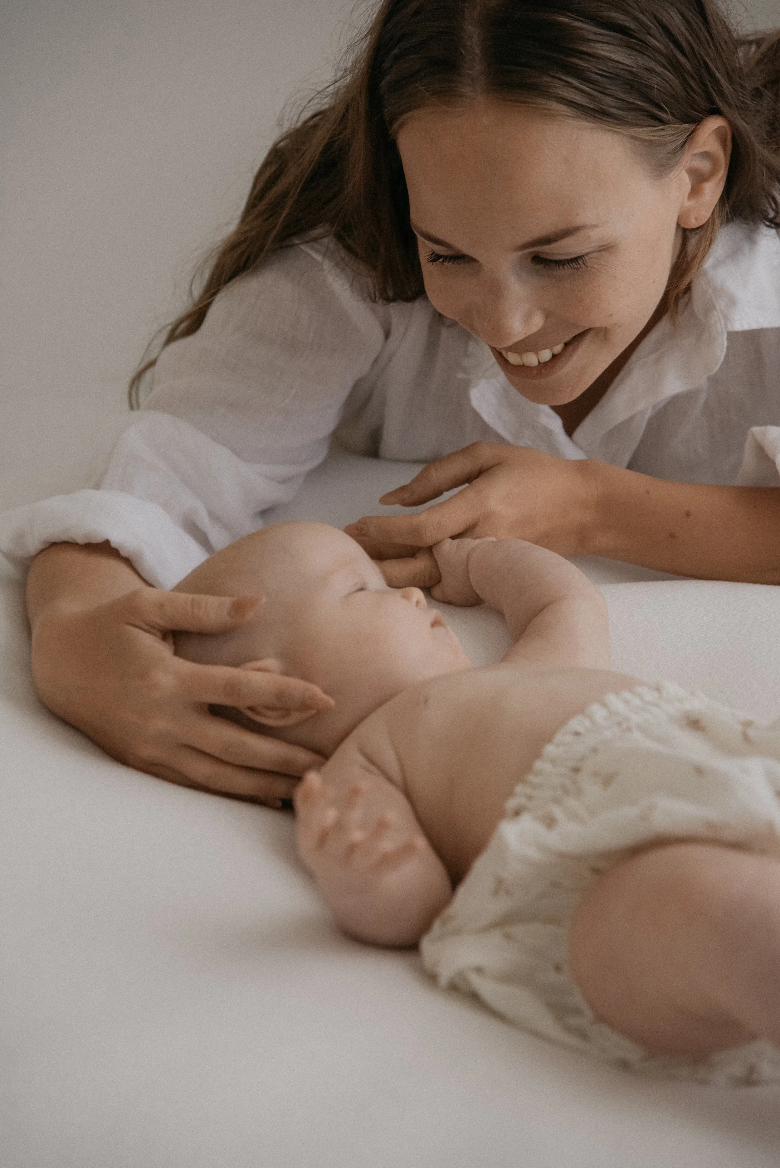 Äidin ja lapsen valokuvaus valoisassa kuvausstudiossa.