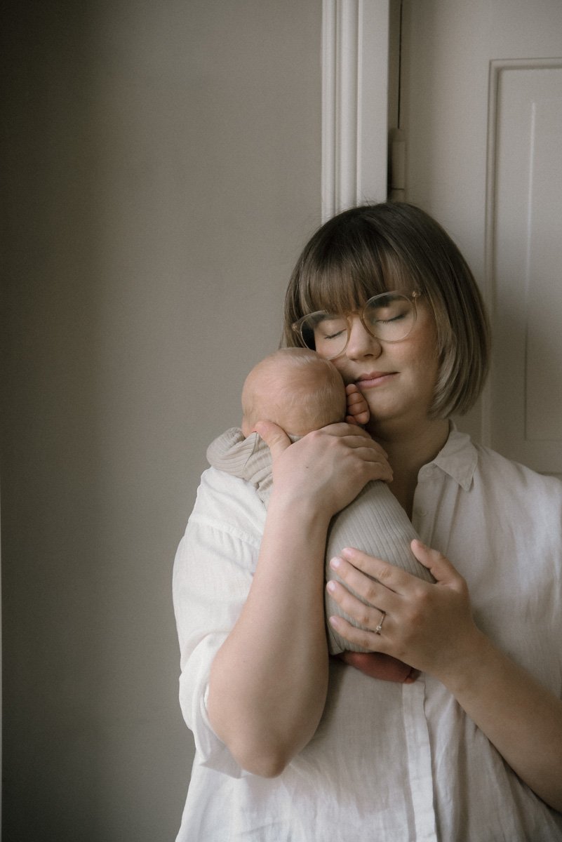 Heidi Väisänen kuvaa äitiä ja vastasyntynyttä kotona. Vauvakuvaus Espoo.