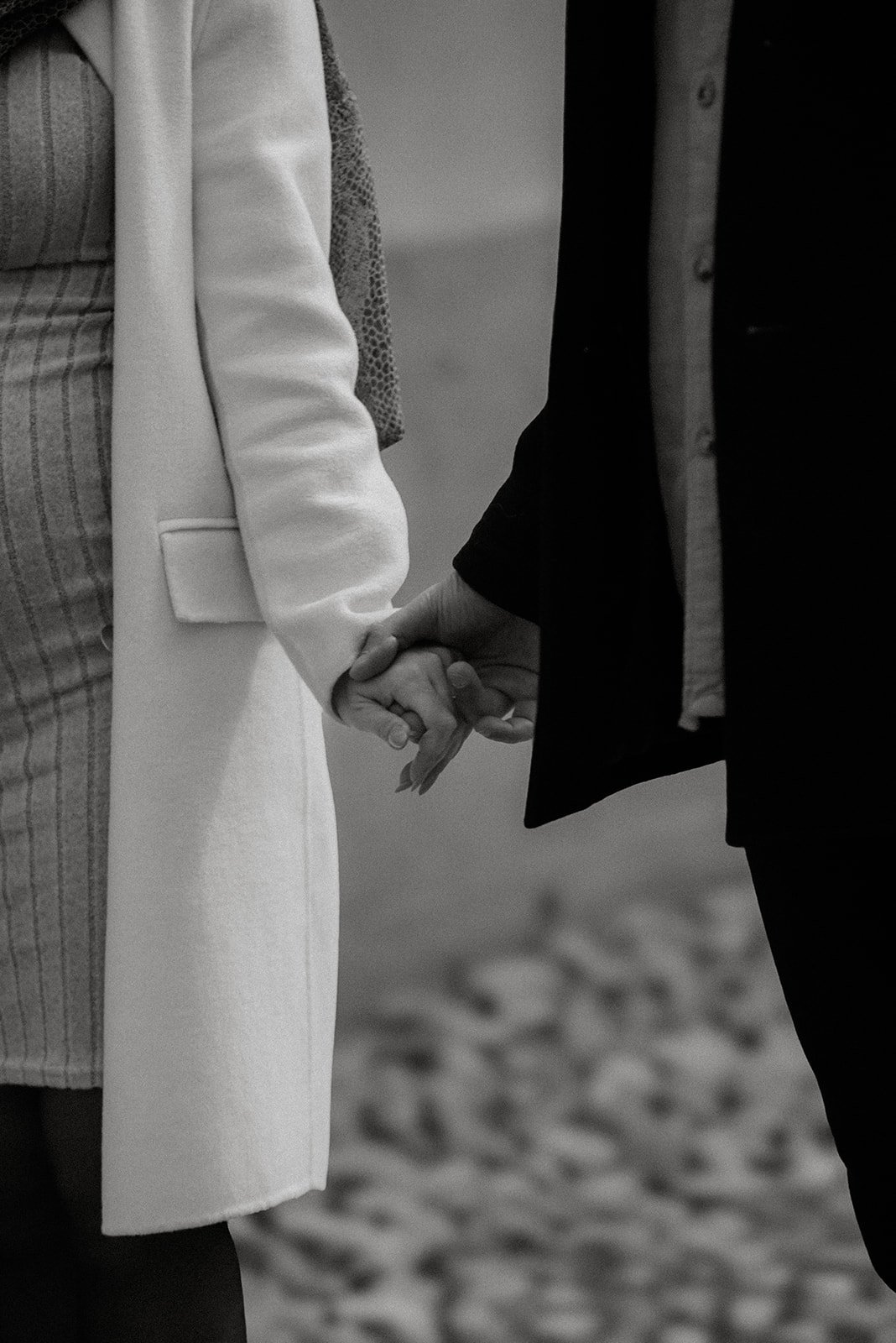 Pariskunta käsi kädessä mukulakivikadulla. Pariskuntakuvaus Helsinki.