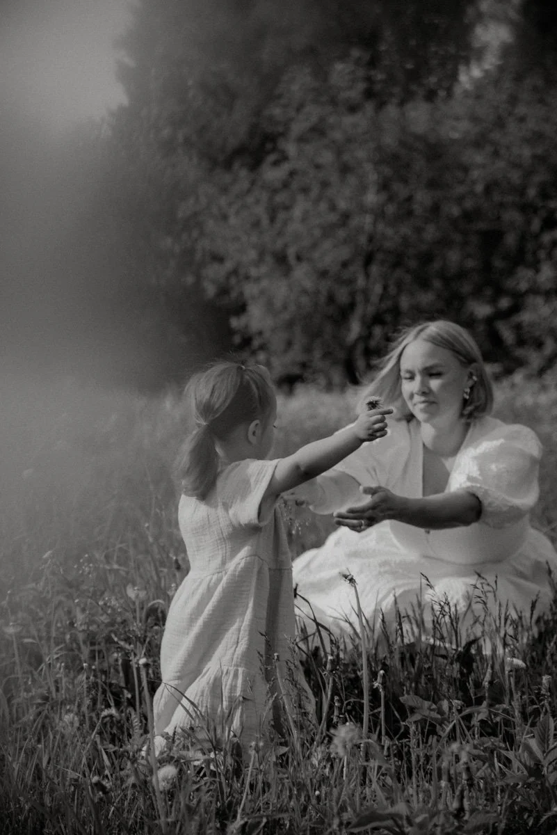 Äiti ja tytär kauniissa luontomaisemassa mustavalkokuvassa.