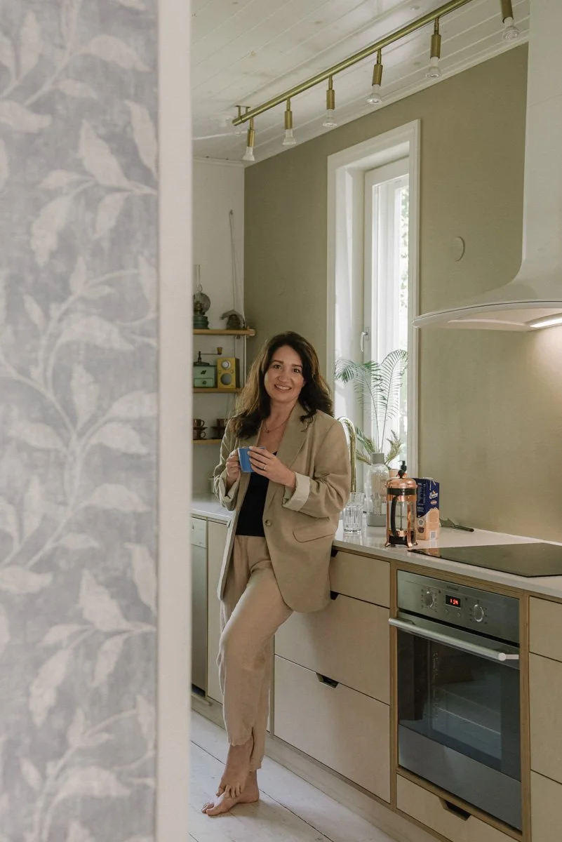 Neam Societyn brändikuvaus, yrittäjä seisoo hymyillen keittiössä.