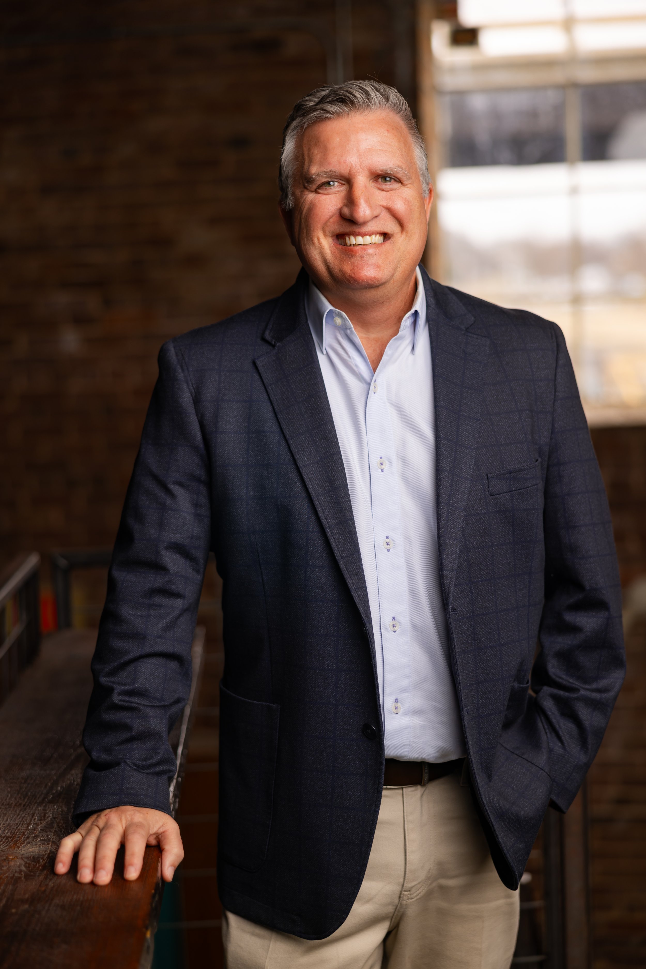 Mark McCary, founder of EagleWorks AI, smiling in a navy blazer.