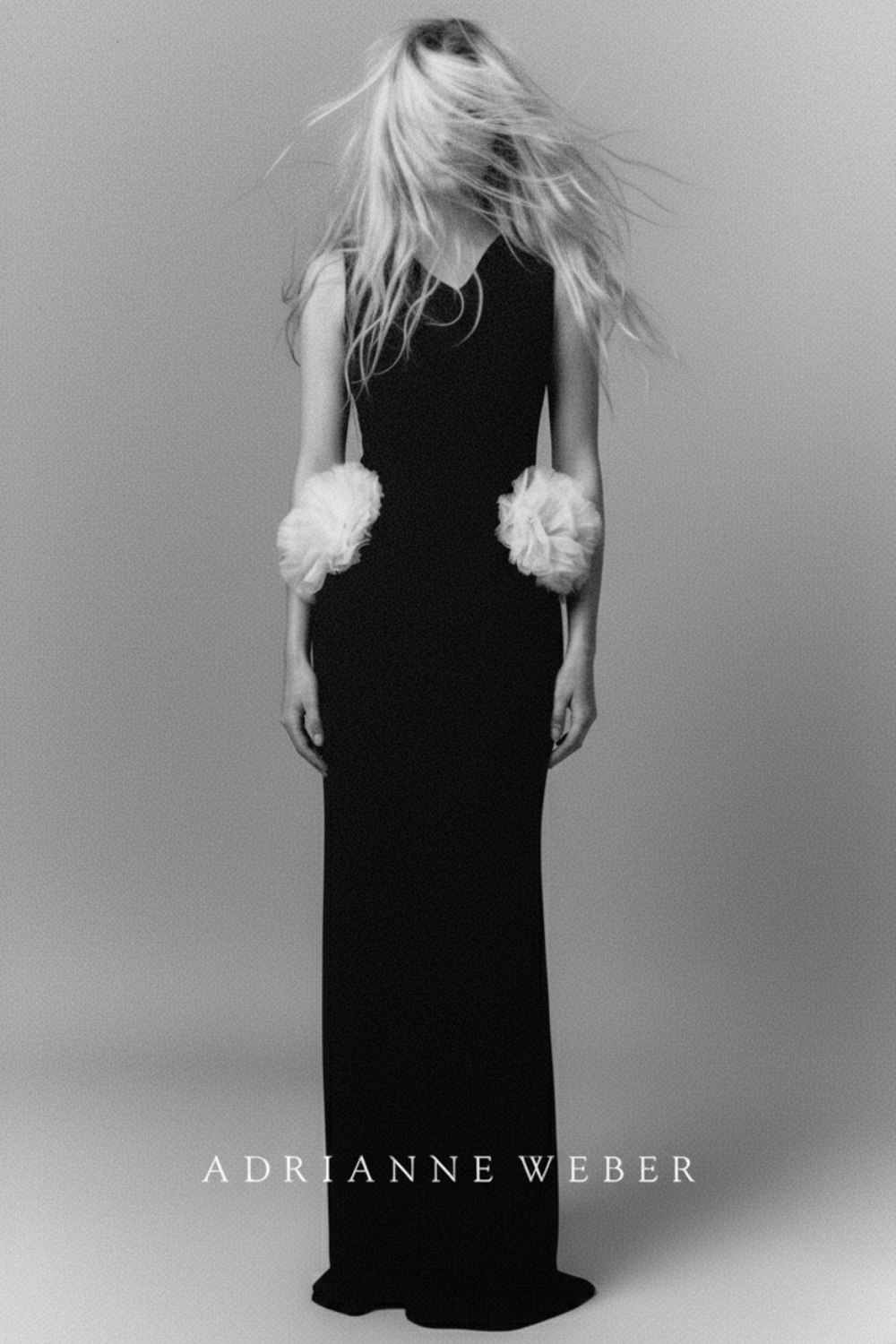 A woman in a long black dress with white floral details on her arms, standing against a plain background with her hair covering her face. The image is in black and white and features the text 'Adrianne Weber' at the bottom.