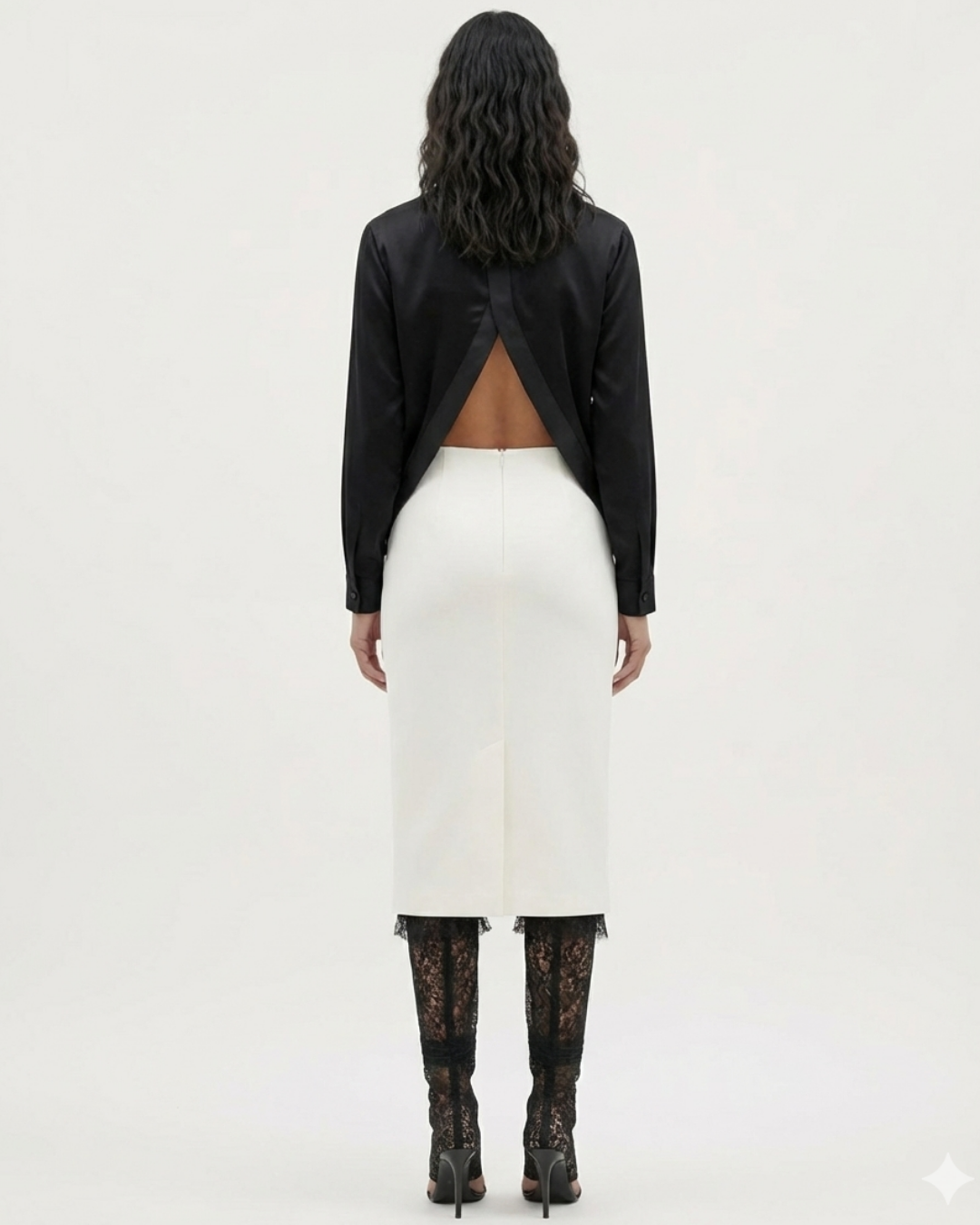 ADRIANNE WEBER Silk Open Back Shirt tailored with a subtle sheen and featuring unexpected architecture as the shirt is designed to be worn tucked, untucked or layered