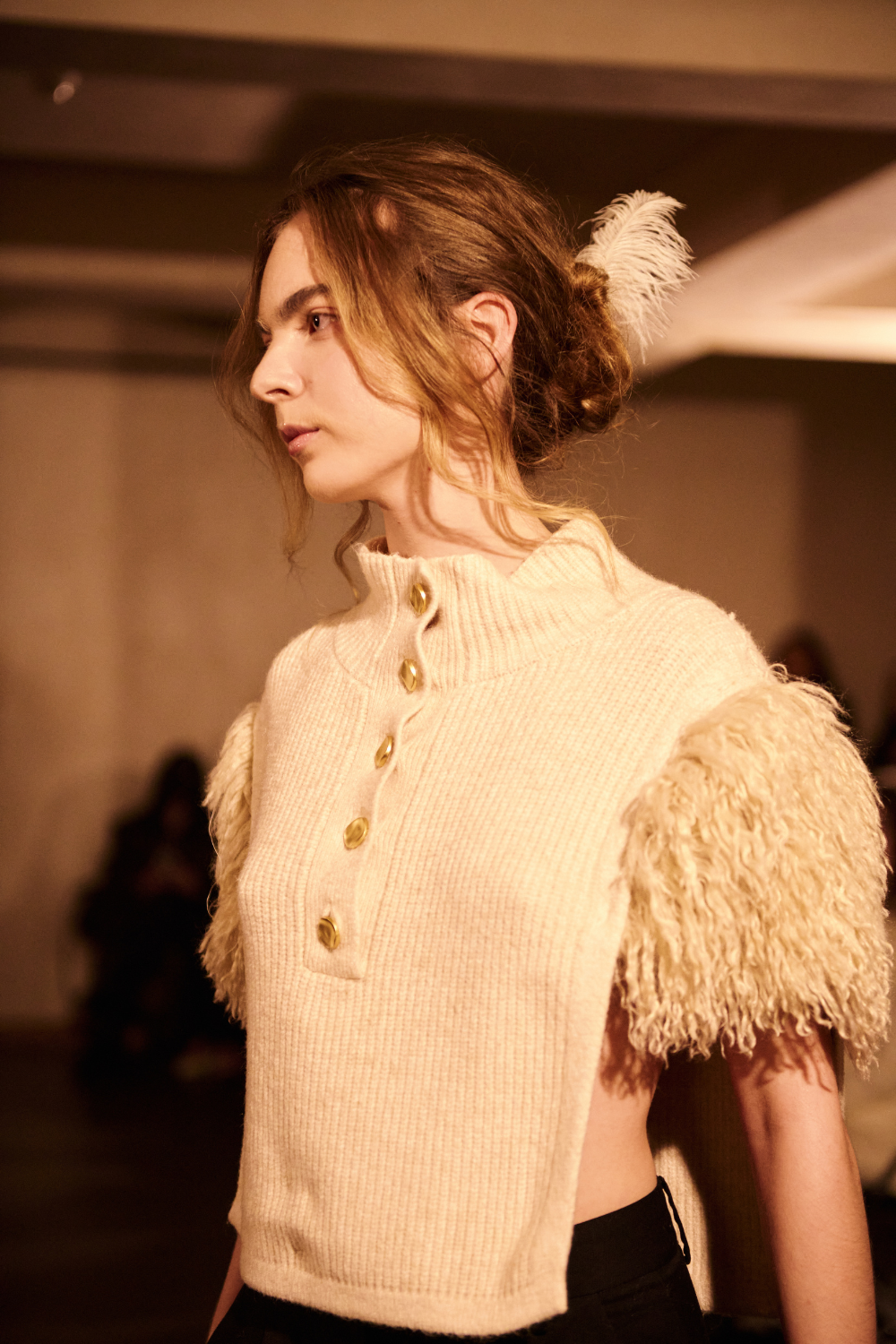 ADRIANNE WEBER Apron Top in dense ribbed wool, raw cut with voluminous shearling sleeves, curled fleece and polished metal