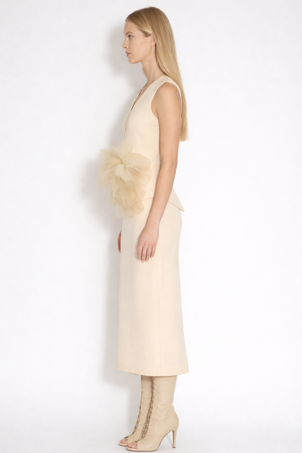 ADRIANNE WEBER Ivory Bloom Waistcoat in premium matte twill, sharp tailored lines contrasted by a handsculpted flower blooming at the hip.