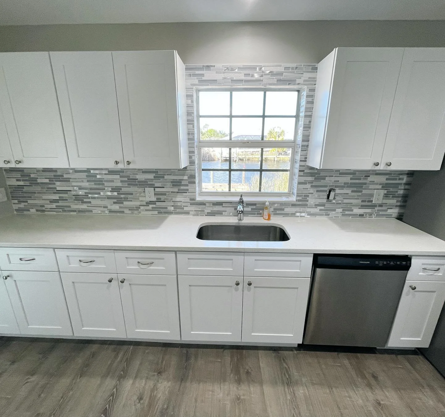 White shaker cabinets are a timeless selection that can be dressed up with countertops and backsplash to give a very elegant look. 