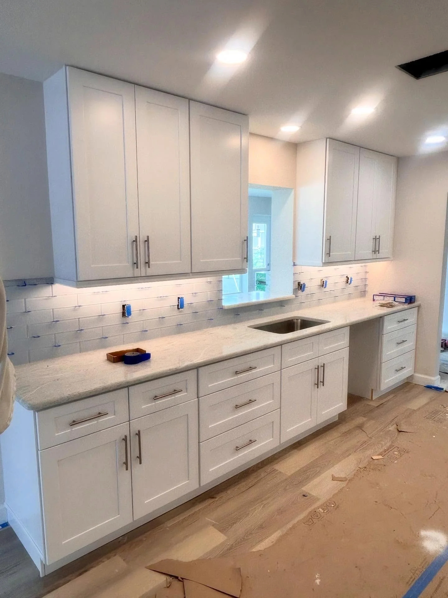 Timeless white shaker cabinets to modernize this Venice home that was badly damaged by Hurricane Ian. 