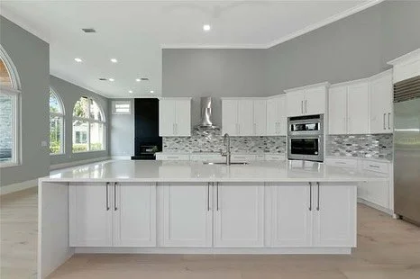 This complete home remodel got a sharp new look. Craftsman shaker cabinets, quartz countertops, all new appliances, and a  modern backsplash to modernize this beautiful home in The Oaks in Osprey