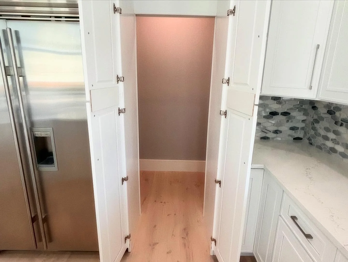 How would you like a secret closet built into your kitchen?  We converted this pantry cabinet to be able to walk through it into an open walk-in closet!