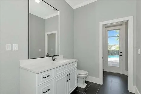 Craftsman shaker cabinets, quartz countertops and sleek new plumbing fixtures for this guest bathroom