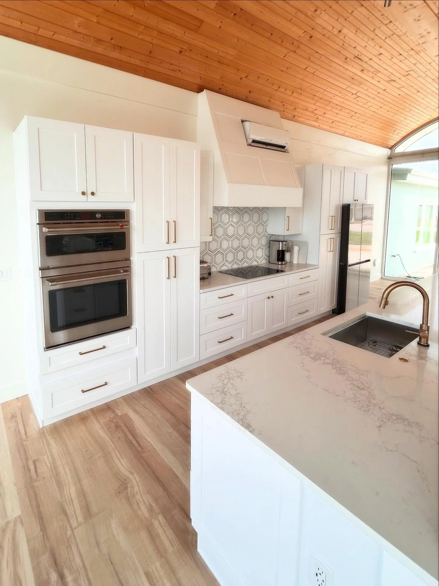Sleek and modern white shaker cabinets give this waterfront Englewood home just the look it needs.  Not too much to take away from the incredible ceilings, but just enough to give the modern feel. 
