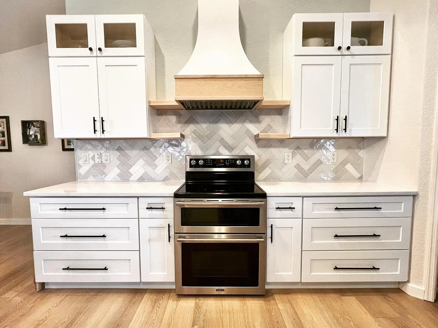 One of our favorite designs, this customer decided on double level upper cabinets and a beautiful wood range hood, in addition to the largest island we've built to date. This kitchen looks like it came straight out of Pinterest!