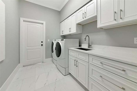Laundry room upgraded with all wood craftsman white shaker cabinets. 