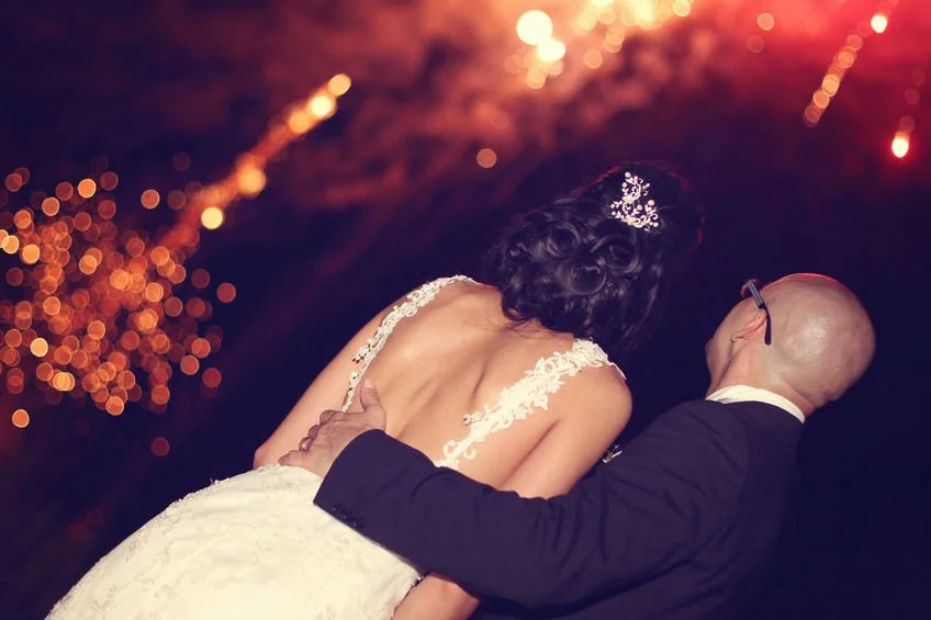 Couple watching fireworks on their wedding day
