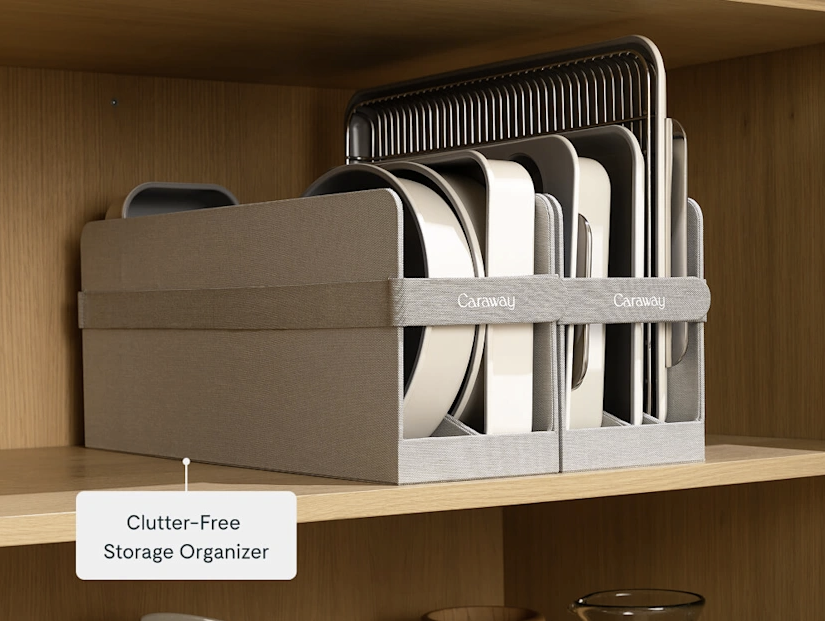Clutter-free storage organizer with plates and cutting boards on a wooden shelf.