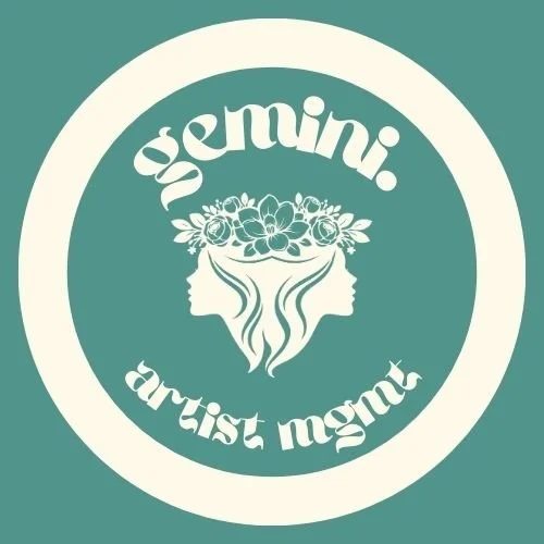 Logo with the words "GEMINI. artist magn" surrounding a graphic of two women's faces in profile, with flowing hair and a floral crown.